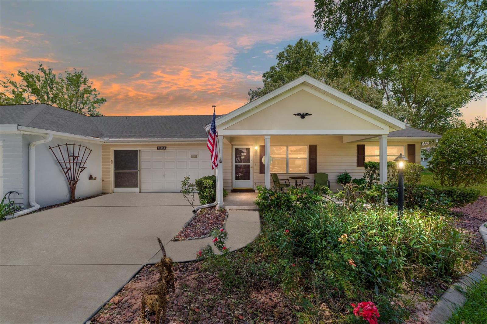 This end unit is unique with the wide open greenspace around your home that you don't have to mow, AND a 2 car garage. Enjoy your mornings on the covered front porch, or the back patio. And an enclosed lanai brings the outside in. There is no carpet inside this 2 bedroom 2 bathroom home with laminate and tile flooring throughout. The primary bedroom features a walk-in closet, and the primary bathroom features a luxurious walk-in mobility tub with hydrotherapy jets for added comfort and relaxation and colored lights for a relaxing ambiance. There are 2 living areas providing options for tv rooms, a craft room, a quiet space, or anything that fits your needs.
Your double driveway leads to the 2 car garage with a storage closet and cabinets. There are screens for the garage door to bring in the breeze while tinkering.
Park your golf cart in here and take a fun ride to grab groceries, or to the hardware store, enjoy dining out, or zip over to one of the pools!
There are activities galore in this community. Pools, biking and walking trails, golf, tennis, dog parks, pickleball, racquetball, along with so many clubs and events to be a part of. Hobby, fitness and recreation centers, an RC flying field and RC car track, bocce ball, horseshoes, archery, indoor racquetball, and so much more! Lawn care, tree maintenance, exterior paint, pressure washing, and trash are included in the maintenance fee. Roof and AC are 2017. The property information provided is deemed to be true and correct, however, Keller Williams Realty Inc., nor its agents, guarantee the accuracy of the information