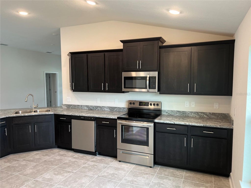 Photo of 132 Bergamot Loop, Davenport, FL 33837 (MLS # O6429425)