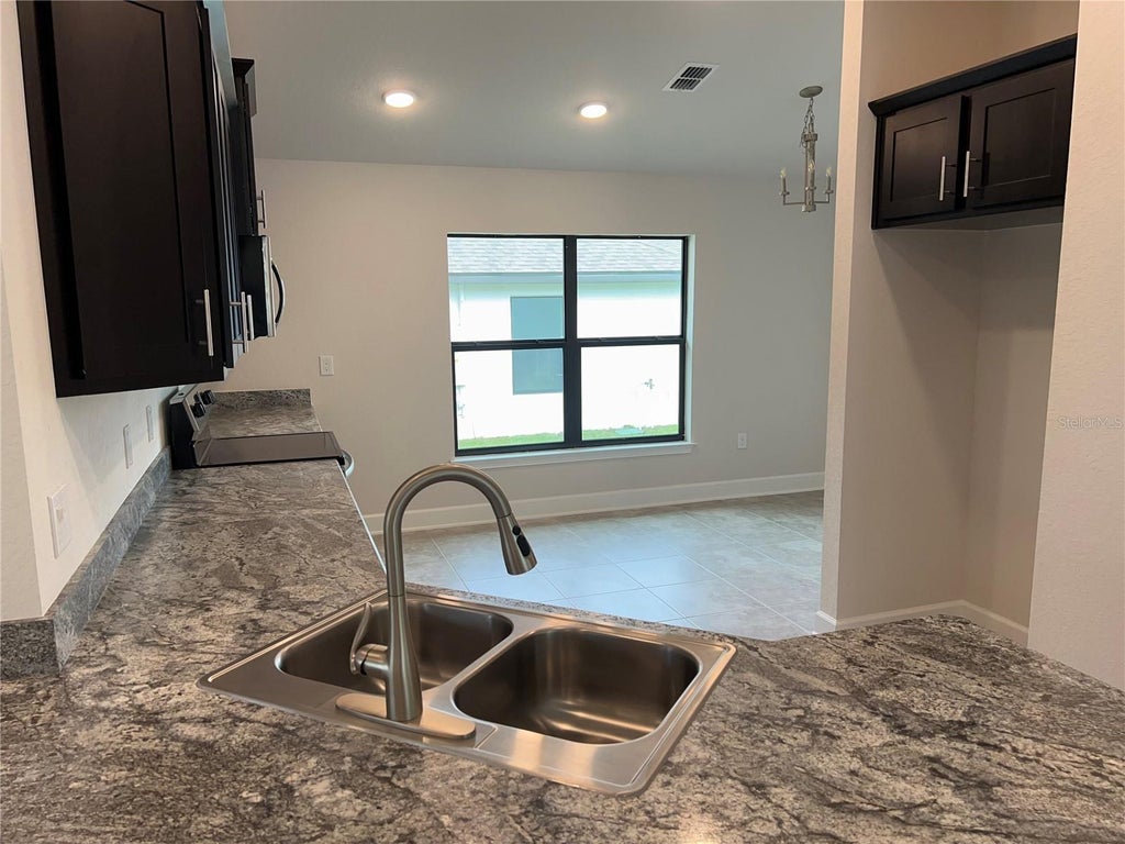 Photo of 132 Bergamot Loop, Davenport, FL 33837 (MLS # O6429425)