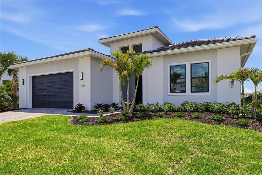 One or more photo(s) has been virtually staged. Welcome to Artistry–Sarasota, where you can experience luxurious resort-style amenities, maintenance-free living and easy access to Lakewood Ranch and Waterside, without the CDD fees. This beautifully designed Van Gogh model offers one of the desirable floor plans available in Artistry. From the moment you enter through the large, double-door entry, you’re immediately welcomed by a spacious foyer with an architectural ceiling and views through the home to the tranquil water beyond. The 12-foot ceilings, generous living areas and abundant natural light will surround you with a sense of serene openness. Practically everything in this home has been upgraded with a focus on minimalist modernism. The large-format tile floors throughout provide elegant texture both physically and visually. The custom cabinetry provides a sleek, uncluttered environment in the spacious kitchen and pristine baths. Calacatta Izaro premium quartz countertops and Hansgrohe and Delta fixtures are featured in each of these areas. The open modern kitchen features a gas cooktop, dual wall ovens and Bosch appliances. Even the 7-inch baseboards, custom 8-foot doors and oversized interior trim are thoughtful upgrades by the homeowners. Reach out for the detailed feature sheet with the lengthy list of features and upgrades. This refined residence provides an optimized, split floor plan that maximizes function and privacy with three bedrooms and baths (two are en suites) located at the corners of the home. The primary suite, positioned at the back of the residence, offers a wonderful respite with water views and evening sunsets. The spacious spa-like bath invites with floor-to-ceiling tile, floating custom vanities, multi-control shower fixtures, a private lavatory and a large walk-in closet. The other baths are similarly appointed with luxury features and privacy. The large flex space adjacent to the great room and kitchen provides lifestyle options: a study for work-from-home, a potential theater/media room or even a large formal dining room, to name a few. The large great room is the center of the home and perfect for relaxing or entertaining family and friends. And, when it’s time for a bit of fresh air, the two sets of triple sliding glass doors will lead you to an extended lanai and beautiful backyard overlooking the water. Even this generously sized area was thoughtfully planned with plumbing and power for an outdoor kitchen and pool. Equally important to all that makes this residence special is what makes it exceptionally safe and energy efficient: impact windows and doors, concrete block construction, a concrete tile roof, spray foam insulation, natural gas utilities and new fiber-optic internet. Community features and amenities include two gated entrances, a huge pool, a clubhouse, tennis and pickleball courts, a playground area and a fitness center, all surrounded by tranquil, landscaped walking paths. Artistry is a maintenance-free, upscale community with no CDD fees, convenient to just about everything that makes Sarasota and Lakewood Ranch desirable, particularly the shopping, dining, entertainment, excellent schools and our destination beaches. There is an art to living well, and you’ll find it here in Artistry-Sarasota!