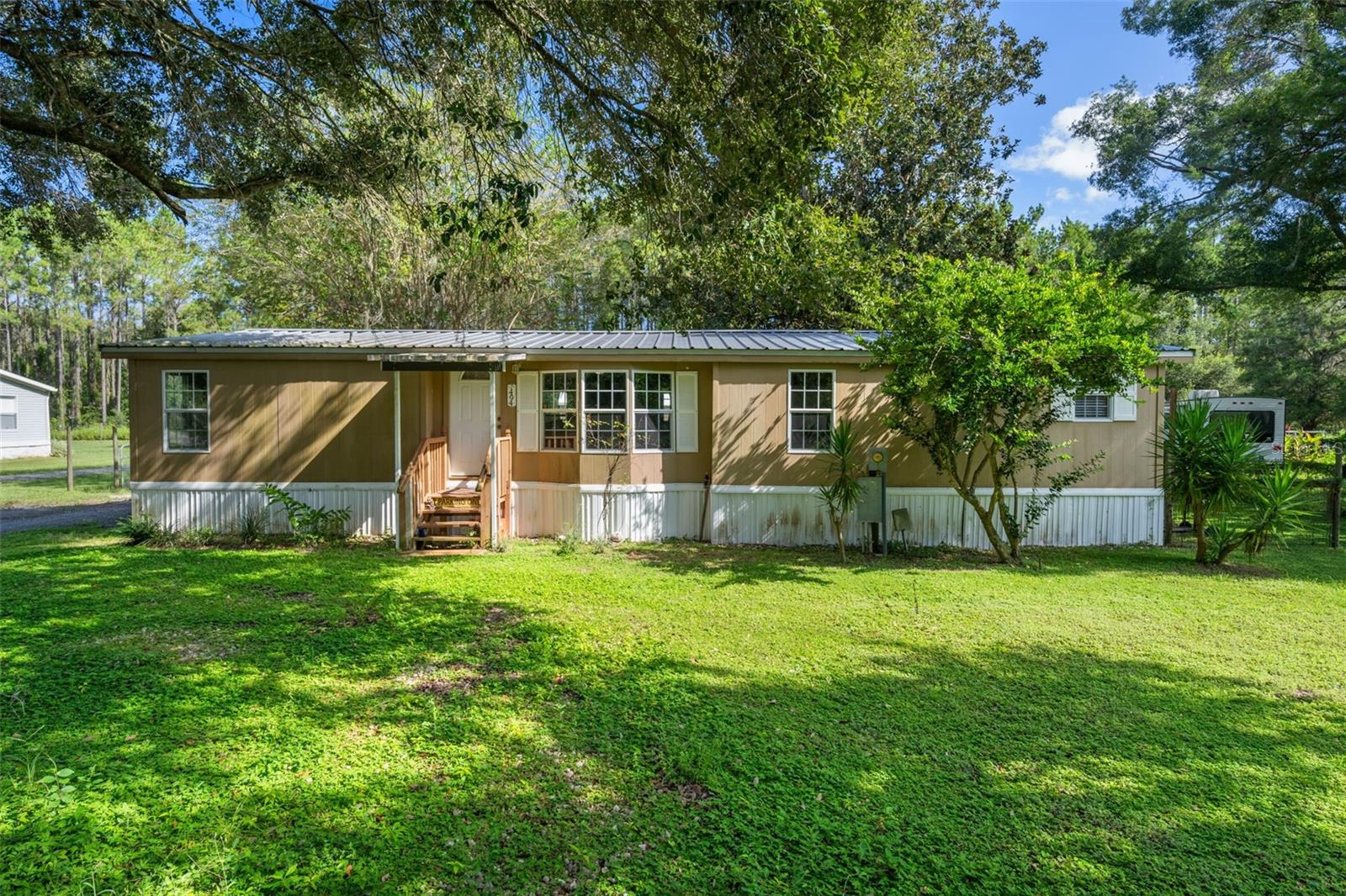 Move-In Ready Double Wide 3 Bedroom 2 Bath Mobile Home Situated On Over 0.58 Acre Lot With A Spacious Backyard. This Home Features A Split Floor Plan, Large Living Room With Cozy Fireplace, Separate Dining Room, And A Generous Kitchen With Abundant Cabinet Space. The Master Suite Offers An En Suite Bath And 3 Closets For Ample Storage. Two Additional Bedrooms Include Walk-In Closets, Providing Plenty Of Room For Family Or Guests. Enjoy Peaceful Living In A Quiet Neighborhood With No Rear Neighbors. Additional Highlights Include A Shed, 2015 Roof, And 2018 AC For Added Value And Peace Of Mind. Located Within Minutes To I-75 And SR-50 You Can Quickly Get To Tampa International Airport, Downtown Tampa, Beaches, Lakes, Trails, Disney And Some Of The Best Springs In Florida Including Weeki Wachee, Three Sisters, Rock, Rainbow, Silver Glen, Juniper, Alexander And Tons More! Live Your Best Florida Lifestyle And Schedule Your Showing Today!
