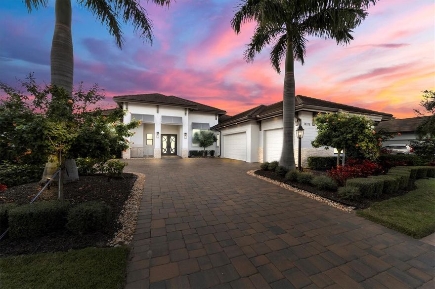 Discover the epitome of luxury living in this spectacular lakefront home nestled within the prestigious gated community of Country Club East. Once the former model home, this residence boasts a spacious design adorned with a plethora of high-end upgrades and architectural details, showcasing a commitment to quality where no expense was spared on additional customizations. Upon entering through the double dark bronze iron doors, you will be greeted by the expansive great room, a focal point with a feature wall and soaring ceilings adorned with white beams. The open floor plan flows effortlessly with gathering areas central to the home and easy access to outdoor living areas. Guests are assured privacy via the split floor plan, each bedroom featuring en-suite bathrooms for unparalleled convenience. Hardwood floors grace all bedrooms, adding warmth and elegance. A sophisticated office with 15-foot tray ceilings adds an element of grandeur, perfect for working from home. A bonus room at the rear of the residence with an en-suite pool bathroom, custom dry bar and wood panel ceilings, provides versatile space for relaxation or entertainment. The kitchen is a chef's dream with a huge island, abundant storage,  gas cooktop, high-end KitchenAid appliances, and an enormous walk-in pantry. The primary bedroom impresses with 13-foot ceilings, custom-built walk-in closets, and a view through double French doors that overlooks the pool and serene lake, bathed in tons of natural light. The primary bathroom exudes opulence with its dual vanities, inviting soaking tub, and spacious walk-in shower, all accented by pristine white tiles and bathed in the soft glow of luxurious light fixtures. The expansive covered outdoor space seamlessly connects with the interior through two sets of sliding glass doors that completely pocket into the walls, creating a harmonious indoor-outdoor living experience. Your lakefront lanai features a custom-built outdoor kitchen with an island, grill, beverage cooler, all complemented by a heated saltwater pool and spa featuring app-controlled temperature, lights, and water features. This home is designed for safety and resilience, featuring hurricane-rated impact glass throughout, and a 22,000-watt natural gas-powered whole-home Generac generator. The spacious 3-car garage is air-conditioned and offers ample storage for all your toys and golf cart. The property is surrounded by new landscaping with custom landscape lighting and an upgraded irrigation system, enhancing the beauty of this already breathtaking home. Indulge in the finest lakefront living, where every detail has been carefully crafted for the discerning homeowner. Country Club East residents enjoy exclusive access to The Retreat, a neighborhood amenity center boasting a resort-style pool, fitness center, and billiards room. Additionally, The Residents Club offers another pool, spa, and a volleyball court for residents to indulge in leisure and recreation. For those seeking even more recreational options, just a few streets away lies the Lakewood Ranch Golf & Country Club, featuring 54 holes of golf, 20 Har-Tru tennis courts, multiple pools, and The Lodge bar/restaurant. Residents have the option to avail themselves of these facilities through various membership packages. Discover this gem in Lakewood Ranch, America’s top best-selling, master-planned multigenerational community. Call today to schedule your showing!