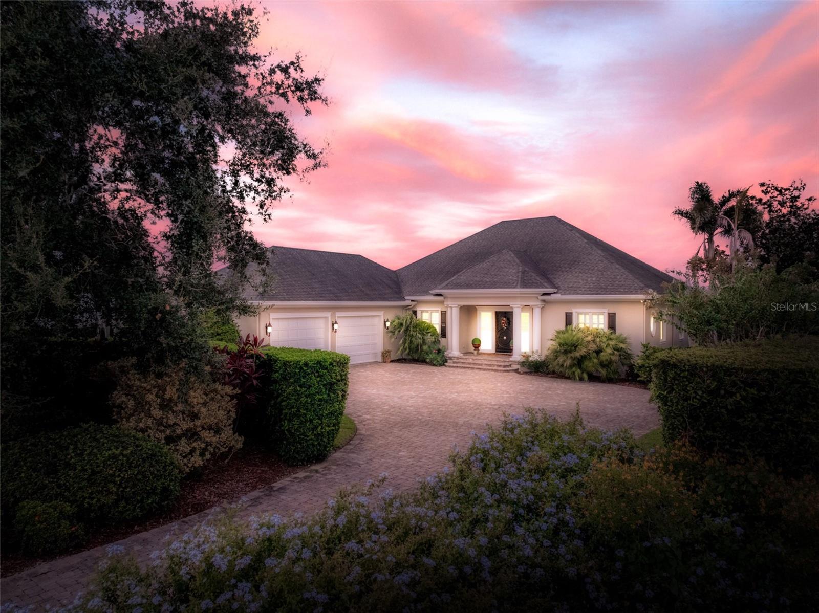 Welcome to this stunning lakefront estate in the prestigious, gated community of Lake June Pointe, where Southern charm meets refined elegance. Perfectly situated on the shores of Lake June in the Winter, the most sought-after lake in Highlands County, this home offers breathtaking panoramic views and unforgettable sunsets that can be enjoyed from nearly every room. From the moment you step into the beautiful foyer, it is clear that this is not your typical lake house, but a luxurious residence designed for both comfort and sophistication. Meticulously built and maintained, the home features wainscoting, crown molding, and ceramic wood-look tile throughout. The open concept living spaces are filled with natural light and framed by the picturesque backdrop of the lake, creating a serene and inviting atmosphere. The gourmet kitchen is a chef’s dream, boasting quartz countertops, a large island, induction cooktop, double ovens, wine fridge, and a spacious walk-in pantry. Flowing seamlessly from the kitchen, the large dining room is perfectly positioned to take in sweeping views of the lake, making it an ideal space for both intimate family meals and elegant entertaining. The home office features custom wood built-ins, providing the perfect space for working from home. The master suite offers a private retreat with electric blinds, a tray ceiling enhanced with ambient lighting, and a walk-in California closet with automatic lighting. Its spa-like bathroom includes a clawfoot tub, separate walk-in shower, dual vanities, and a private water closet. Downstairs, the walk-out lower level is surrounded by earth on three sides, offering both energy efficiency and privacy while still showcasing spectacular views of Lake June. This level includes an expansive family room, a gym, a secure safe room, an ensuite bedroom, a guest bedroom and bath, and access to a large, screened patio. Additional highlights include an oversized garage with an extra storage room, offering ample space for vehicles and lake toys, as well as a well-appointed laundry room featuring custom wood cabinets and a built-in work desk. The exterior of the home is equally impressive, with a paver circle driveway, walkways, and a lakeside patio and walkway that leads to a composite dock and private boathouse, perfect for enjoying the lakefront lifestyle. Two oversized screened patios provide ample space to relax and soak in the beauty of the surroundings. For added peace of mind, the property is equipped with a whole-house 100 KW generator. Centrally located in Florida, this exceptional home offers the perfect blend of luxury, comfort, and convenience, making it an ideal retreat while remaining accessible to both coasts. With its unparalleled craftsmanship, thoughtful upgrades, and captivating views, this home truly defines premier lakefront living in one of Highlands County’s most exclusive communities.