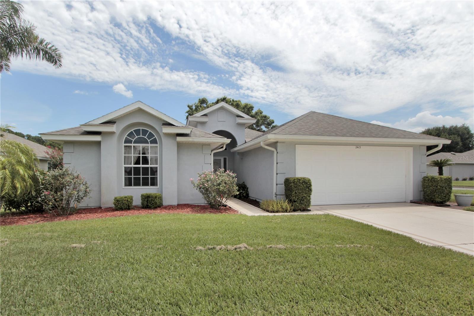 One or more photo(s) has been virtually staged. PRICED TO MOVE! Boasting 1700 SQ FT of thoughtfully designed living space, this 2 BDRM/2 BATH home awaits your personal touch. The SPLIT LAYOUT also offers a large BONUS ROOM, perfect for a home office, craft room, or possible use as a 3rd Bedroom with the addition of a closet. The OPEN FLOOR PLAN seamlessly connects the living, dining, and kitchen areas—ideal for both entertaining and everyday living. The heart of the home? A SPACIOUS Kitchen featuring an island/prep station, ample cabinetry, and GENEROUS counter space—a dream for any home chef! Just off the kitchen, enjoy the added convenience of an INDOOR LAUNDRY ROOM with a Washer & Dryer INCLUDED! A SUNNY Dinette adjoins the kitchen leading to the GLASS ENCLOSED Lanai, perfect for morning coffee or evening gatherings. Plus, major updates give you peace of mind: New Roof (2020) & AC (2025). Priced “As-Is”, the furniture on-site (Living Room, Dining Area, Dinette & Lanai) is included, as is the chest freezer in the garage. Enjoy all the community amenities including the heated pool, spa, library, fitness room and social hall. HOA fees cover lawn mowing, watering, landscape trimming and an annual house power washing. DON’T LET THIS AWESOME OPPORTUNITY GET AWAY!