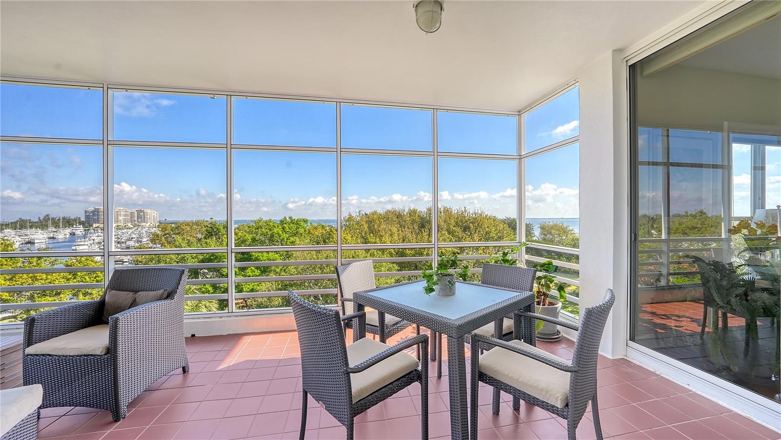 The most beautiful vistas of Sarasota Bay, Harbourside Golf Course, and Moorings Marina are the perfect welcome as soon as you enter this fourth-floor, corner Marina Bay residence. Natural light filtering through walls of glass sliders and oversized windows creates a brightly inviting atmosphere to move right into and immediately begin enjoying. The thoughtful design encompasses nearly 3,100-square-feet of living space adorned with lovely updates you will love, including beautiful hardwood flooring, custom built-ins, neutral, warm tones, plus upgraded plumbing, electrical and brand-new (in 2022) air-conditioning systems. This unique community combines single-family living with the conveniences of luxurious accommodation, while still feeling perfectly secluded. From the secure, under-building parking, you enter your residence through a private, extended entry that opens to the stately foyer, with the expansive living and dining room areas beyond. The largest of the east, west and sunset facing terraces is an inviting, screen-protected spot to relish bay and marina views coupled with ideal breezes. The modernized kitchen (by Scott Frieler) overlooks the family room and is an ideal chef’s space featuring designer cabinetry in a sleek finish, Quartz countertops, full tile backsplash, professional-grade stainless steel appliances, generous island with wine storage, planning desk and pantry. The primary bedroom is a secluded retreat with his/her walk-in closets, inspired en-suite bathroom overflowing with recent upgrades and its own terrace. Two guest bedroom suites are arranged in a split plan, each offering updated bathrooms (all updated by Scott Frieler), and one suite is currently being used as a den. A fantastic place to escape, Marina Bay is an intimate neighborhood comprised of only 60 residences, in a delightful location behind the exclusive gates of Longboat key Club Harbourside. The options for relaxation at this resort-style community are endless. Residents appreciate the convenience of the 24-hour manned Bay Isles guard gated entry and on-site management, as well as having access to enjoy fitness center, tennis, barbecue station with gas grills, bayfront sundeck with gazebos, lounging and dining areas, plus heated swimming pool and spa. Deeded access to the residents-only Bay Isles Beach Club is only a sunny bike ride away. Room Feature: Linen Closet In Bath (Primary Bedroom).
