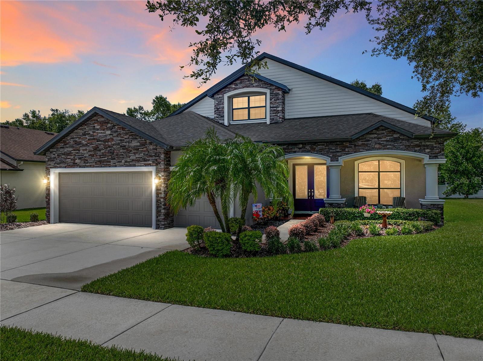 Absolutely stunning 4BR/4BA home nestled in the established community of Starling Ridge. Upon entry, you find travertine and wood-look laminate throughout the entire home (with only carpet on the stairs) and crown molding in the common areas on the lower level. To your immediate left is the formal Dining Room perfect for those holiday gatherings and entertaining guests. To the right are glass french doors leading you into the office where you will find ample lighting as well as a spacious area for creativity and productivity. Moving into the home, you will find yourself in the open concept Great Room perfect for game nights with friends and family. The Great Room flows into the Kitchen and features sliders to the lanai. The Kitchen has so many features including a large eat-in area, stone counters, a 4 appliance GE suite in stainless steel with double oven, breakfast bar, lots of cabinetry and counter space. As you look around the Kitchen you will envision whipping up weekend breakfasts or even family dinners where everyone gathers to connect. Also on the first level is secondary bedroom and full bathroom, nice for visitors or a multi-generational arrangement. Off the Great Room is the conveniently located Primary Bedroom boasting an En suite bathroom with a dual sink vanity, good-sized walk-in shower, and large walk-in closet. Moving up the stairs you find the Bonus Room with extra storage space and a reading nook, additional full bathroom, 2 additional bedrooms, both with walk-in closets, and connected with a full jack and jill bathroom. Enjoy your weekends out on the screened lanai or back patio that includes a built-in bench and fire pit. A great place for morning coffee or weekend get-togethers! Schedule your showing today.