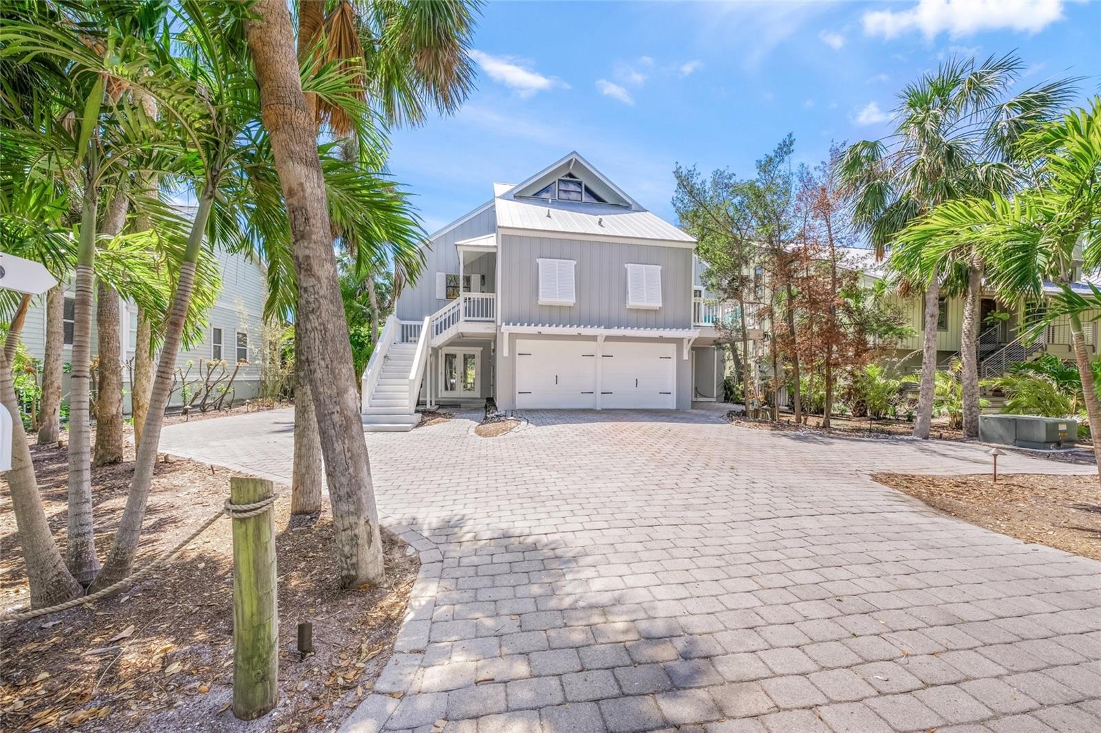 This newly renovated (March, 2025) 3 bed, 4 full bath home with a deep water dock just down the street is located within walking distance of the famous Siesta Key Beach. The one of a kind house was design by the Sarasota School of Architecture. The master and main guest bedroom are located on the main level along with the kitchen, living, laundry and dining rooms. An additional bedroom and full bath, with its only living room are located on the ground floor with private patios front and back. Think in-law suite. In addition an office/bonus/exercise room is located on the ground floor. The third floor host a loft with a full bath and entertainment area. A full wrap around deck covers the back of the home. The master and guest have a private deck as well. 2 car garage with built in storage. Additional parking left and right side of driveway. House comes fully furnished. 8 month min. lease, available today.