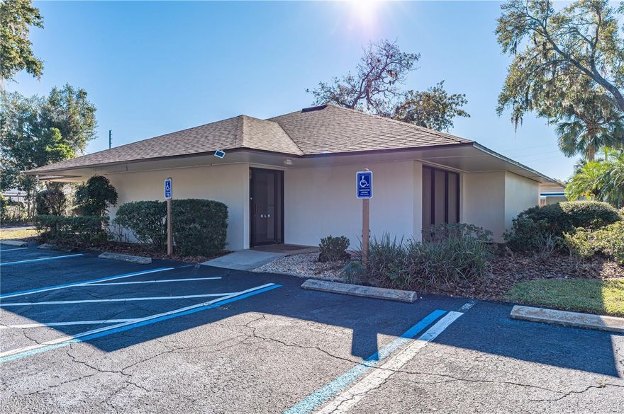 Medical Professional Office directly on S US Hwy 19 (Bay Street) & E. Wilt Avenue, and is included in the Eustis Central Business District.  Half acre lot with 21 parking spaces.  New roof 2024, AC's 2023, remolded in 2022 including flooring, interior and exterior painting. Built in 1982 but the effective year is 2004-major renovation.  Shared reception and front work area, the back offices are split into somewhat identical sides. A  nice scenario would be to use one side and lease out the other. Owner parking is behind the building, each unit has two separate metal doors for access, security system, 2 car metal carport and 21 parking spaces.  Easy access with the property being located on a corner.  Enter and exit the parking lot from Wilt Ave or directly on Bay Street.  The back half of the building is designed identical which creates the two offices, each side has a consultation room, 3 exam rooms, minor procedure room, nurses station, scale designated area, dressing areas and 2 individual rest rooms, including the back private entrance for the professional.  Front and shared areas: Staff lounge, work room, chart room laboratory, x-ray, reception, waiting area, and plenty of storage.  This building is in beautiful condition, has plenty of parking and is ready for one or more professionals.