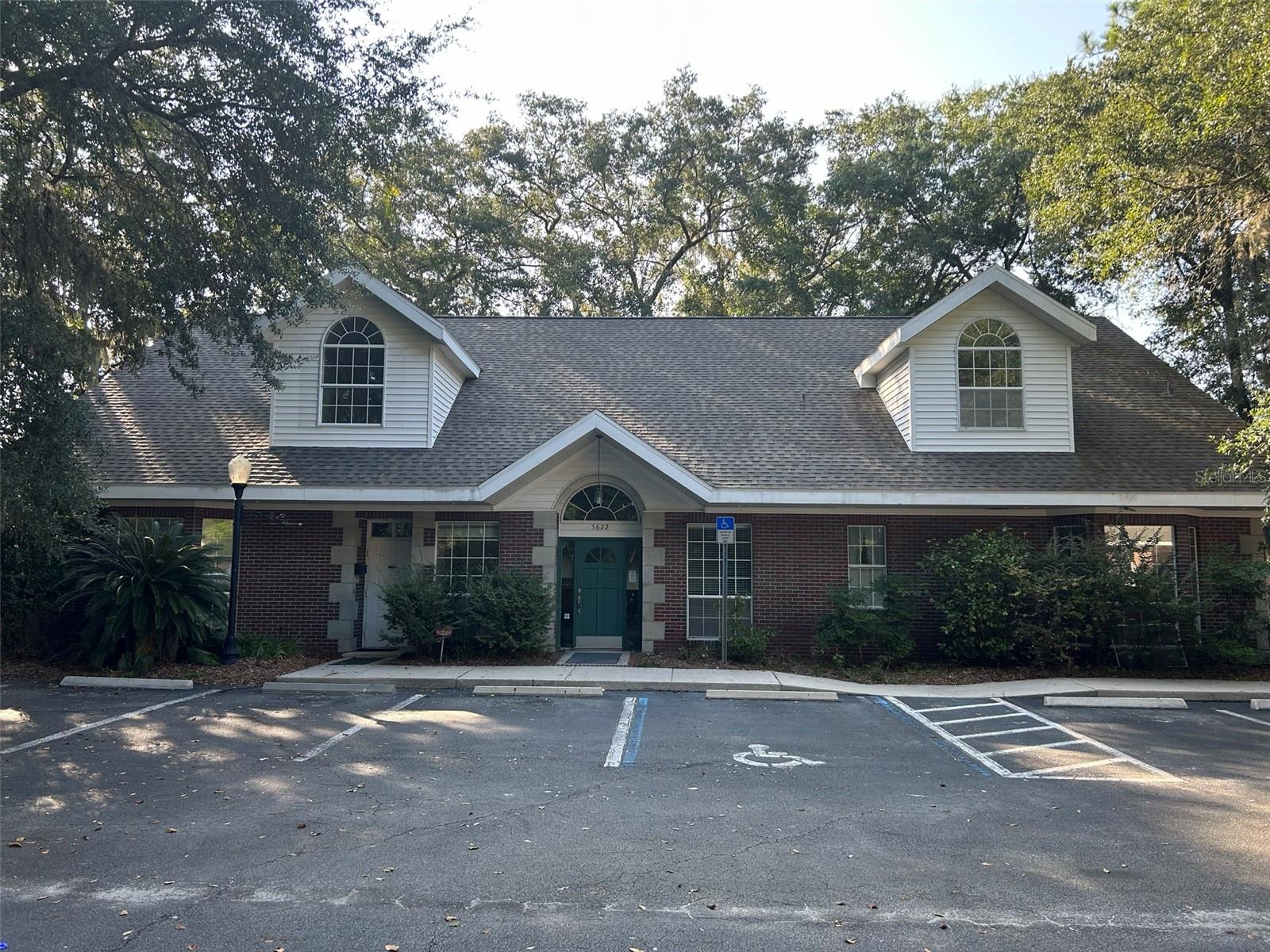 Welcome to your new professional office space at Waterford Park, nestled on Gainesville's prominent professional corridor along NW 43rd Street. This purpose-built, two-story building was originally designed as a dental medical facility, featuring a second-floor conference area and a separate living space upstairs. Ideal for a professional office, this property offers a spacious lobby, a reception desk, eight office/exam rooms, two administrative stations, a copy room/file room, an executive office with a private bath, a business office, a kitchen, storage facilities, a lab/break area, full baths with showers on both floors, and two half baths.
Positioned backing onto NW 43rd Street, this building benefits from its visibility to passersby. The area is in high demand among various professionals, making it an excellent location for accountants, attorneys, doctors, dentists, physical therapists, occupational therapists, veterinary services, creative professionals, engineers, and architects.