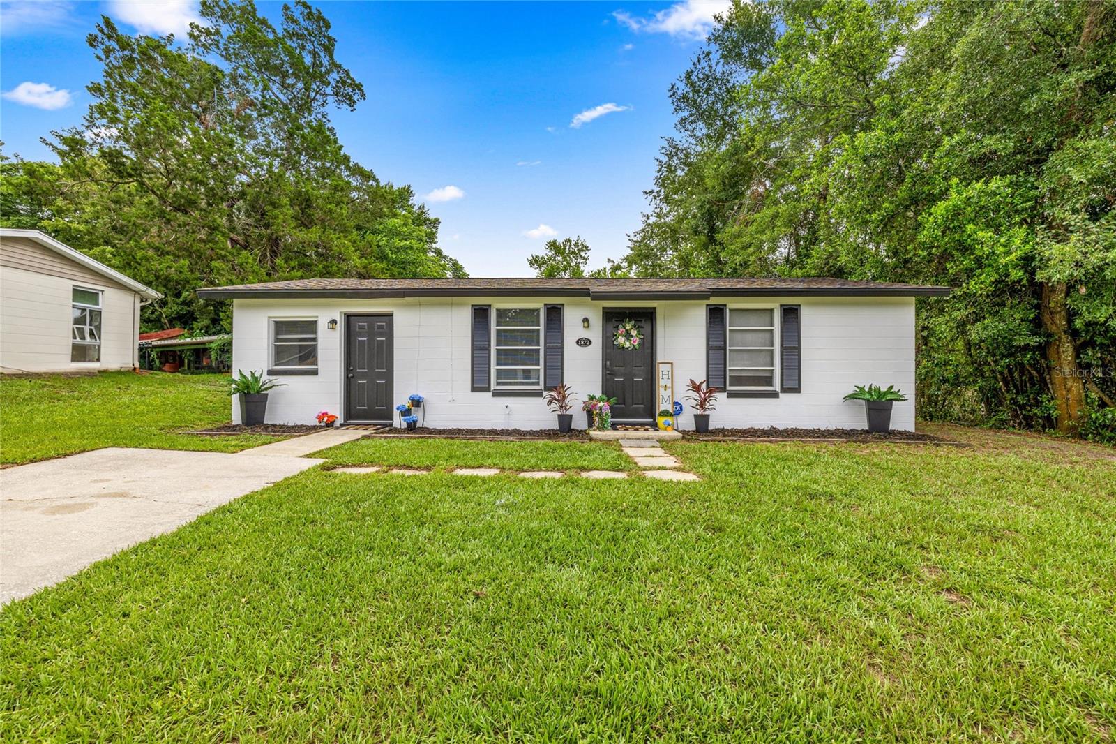 One or more photo(s) has been virtually staged. Investors—act fast! This move-in-ready 2-bed, 902 sq. ft. home is packed with updates and ready to generate rental income or serve as a great starter home. New roof (2017), HVAC (2019), fresh interior paint, vinyl plank flooring, and full exterior repaint and pressure washing in June 2025. Fresh landscaping, new exterior light fixtures, and a private tree-lined backyard add curb appeal and privacy. Inside: modern bathroom with oil-rubbed bronze finishes, stainless steel oven and fridge, and built-in shelving in the primary bedroom. Located in a quiet neighborhood near schools, parks, and major roads—and central to Central Florida’s springs for biking, hiking, paddling, and weekend getaways. This one won’t last!