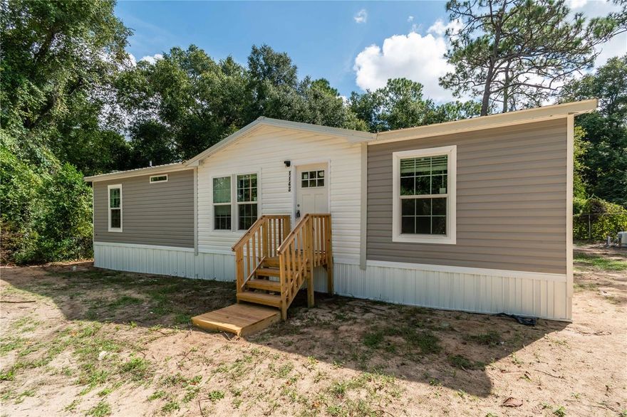 Brand New 2024 3/2 Mobile home with 1344 sq ft heated living space. Brand new septic and well. The open concept layout includes luxury vinyl flooring throughout with carpet in the rooms, ensuring ease of maintenance. Enjoy enhanced privacy with split bedrooms and entertaining guests in the spacious family/kitchen combination. The inside laundry room simplifies daily task, while ample closet spaces provide generous storage for personal belongings. Situated right off of Hwy 40, this home enjoys a prime location with easy access to main roads, making commutes a breeze. For Equestrian enthusiasts, the World Equestrian Center (WEC) is a just a short drive away. The surrounding areas offers a wealth of amenities, including shopping, dining, parks, and recreational activities, ensuring that everything you need is within easy reach. Schedule your showing today and discover the endless possibilities this beauty has to provide.