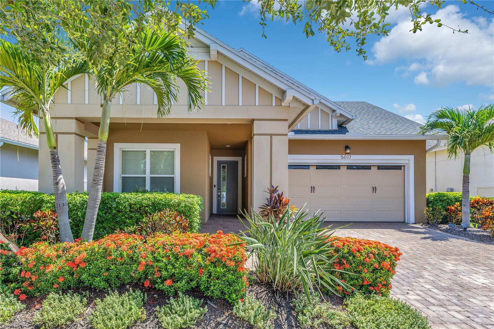 Welcome to a true resort style haven reserved for active adults 55 and better. The paver drive and lush landscaping set a welcoming tone that continues inside where sunlight pours across a meticulously maintained home equipped with large format tile, high ceilings, and an open plan that effortlessly links living, dining, and the kitchen. Granite counters, rich wood cabinetry, a gas range, and pendant lighting create a gathering spot that feels both polished and comfortable.
The split bedroom layout keeps the primary suite private. It offers a tray ceiling, a deep walk in closet, and a spa shower with frameless glass, dual heads, and bench seating. Two additional bedrooms sit toward the front of the house alongside a flexible office or hobby room. A guest bath with granite vanity, plus a laundry room outfitted with upper cabinets, a utility sink, and folding space, make daily life easy.
Step through pocketing sliders and you will see the upgrade everyone talks about. The GIANT screened lanai runs nearly the full width of the home, giving you room for grilling, dining, and lounging without ever feeling cramped. It has both a space for catching sun rays and under the shade.
Twin Lakes handles yard care so weekends are free for lakefront fun. The clubhouse delivers state of the art fitness facilities, a lagoon style pool, a separate lap pool, hot tub, grilling pavilion, fire pit, tennis and pickleball courts, bocce lanes, and a putting green. A private pier lets you kayak, paddle board, captain a boat, or fish on pristine Live Oak Lake. All of this sits minutes from Lake Nona Medical City, the Turnpike, and Orlando International Airport.
If you want easy living in a vibrant fifty five plus community where every day feels like vacation, this home is ready for you.