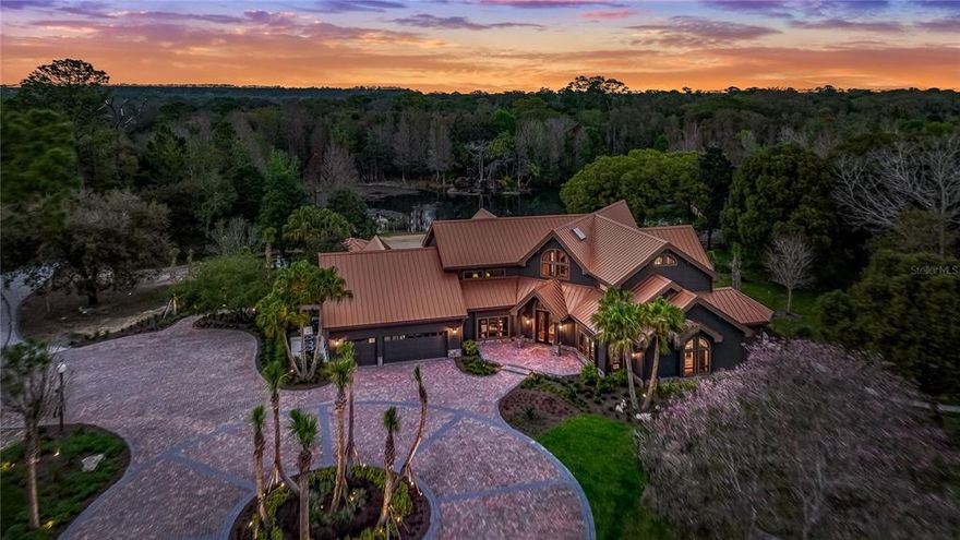 Welcome to 4015 Country Club Rd, a RARE one-of-a-kind Equestrian Estate located on the scenic Country Club Rd in Winter Haven, FL. This stunning estate features 55+ Acres of some of the most beautiful “old Florida” land you will find! As you enter the gates you are greeted by a long brick paver drive leading you back to the heavily tree'd and secluded home. The property is made for the horse enthusiast, equipped with a 17,000 sq ft show arena, 6 stall barn, additional 2 stalls and office/workshop detached to main barn, tac room, 2 fenced paddock areas, horse riding trails, two gazebos, a large hay field that could be additional pastures, a private pond, in-ground pool, fire pit area, dock for fishing, and extravagant landscaping and trees like you've never seen before! Inside, the owners have updated and upgraded nearly every square inch of this stunning home. As you walk in the massive french doors, you are greeted with a split staircase and a view that is truly unique to this property. The home features 3 large master suites, with additional rooms if more bedrooms are desired. The master suite is extremely spacious and has a stand alone tub, a separate walk in shower and 2 large walk-in closets with custom built-ins, and a sitting area with spectacular views for your morning coffee! Off of the Master suite is a cozy office/den with lovely built in bookshelves. The kitchen has received a complete face lift, with all new kitchen cabinets, leathered granite countertops, Sub Zero panel ready appliances, a 6 burner + Griddle Wolf gas range and built in Wolf oven and microwave. Off of the kitchen, the owners added a custom bar that will be THE conversation starter for everyone who walks through this home. The bar is Custom built from solid American Black Walnut by Robert Berganza. A true work of art with hand selected walnut using a “sister” board process to construct each panel through out.  Finish is “oil rubbed” to give it an authentic appearance, with no chemicals. No screws or nails except for doors and drawers. Solid brass water fixtures and beer tap. Brass foot rest. Subzero dual temperature Wine cooler, double drawer subzero refrigerators, Perlick kegerator, ice maker (not delivered yet). There is also a full bathroom with access outside to the pool area next to the massive laundry room. Upstairs, you will find another master suite or guest suite, featuring its own sitting space with stunning views of the oak hammock and riding arena. Opposite of that room, the 3rd suite, currently being used as a 2nd home office for the owner. It has some of the very best views, overlooking the pool and pond areas. The owner is adding a private wine/spirits closet, that could easily be used as a traditional closet space. Inside the suite is another full bathroom as well. Additionally upstairs, you will find an oversized bonus room, currently used as a craft room for the owner, but could be a game room/den/4th bedroom if needed. There is an unbelievable amount of storage space available in this room. The property has 2 electric gates, 1 designed for service vehicles to use. The Arena is PERFECT for hosting fundraising events or even weddings, if you didn't want to use it for horses. There is a large platform on top of the 6 stalls for entertaining space. The property even connects to the Winter Haven Country Club! This property truly cannot be described in words, as we invite you to come view this special piece of Florida paradise in person!