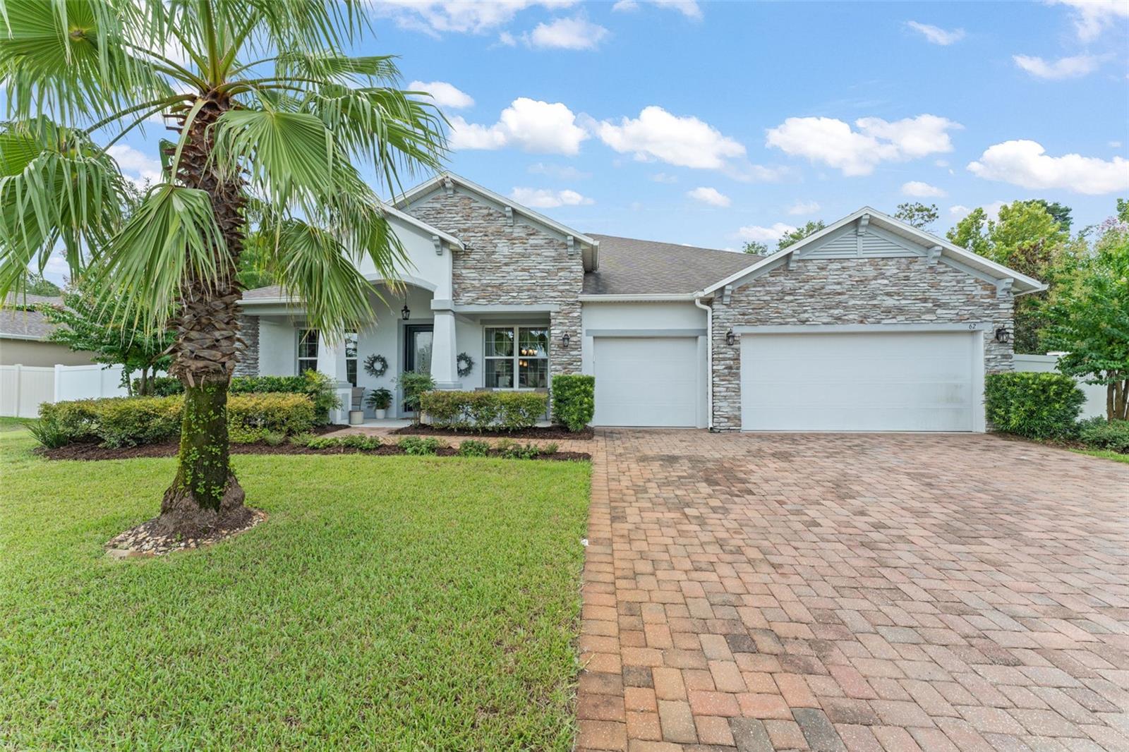 **This property qualifies for a closing cost credit up to $8,300 through the Seller’s preferred lender.**Welcome home to this beautifully maintained 2016-built home offering the perfect blend of style, space, and comfort. Nestled on a .45-acre lot, this stunning property features a stone-accented front elevation, a paver driveway, a 3-car garage, and a charming front porch that welcomes you home. Step inside to discover a thoughtfully designed layout with formal and flexible living spaces. The elegant formal dining room is highlighted by a tray ceiling and crown molding, setting the stage for special gatherings. Across the foyer, a versatile flex room with glass-paneled French doors makes an ideal home office or creative space. The heart of the home lies in the open-concept kitchen and living area. The chef’s kitchen boasts a massive island with breakfast bar seating, stainless steel appliances, and a walk-in pantry with a stylish accent door. Just off the kitchen, the spacious living room is filled with natural light and features sliding glass doors that lead to your private backyard oasis. Designed with privacy in mind, three bedrooms and two full bathrooms are located on one side of the home, while a separate bedroom and bathroom are tucked away on the opposite side—perfect for hosting guests or creating a private retreat. The primary suite is a serene retreat, complete with backyard views, a luxurious ensuite bathroom offering a glass-enclosed shower with dual shower heads, a double sink vanity, and a walk-in closet. Out back, unwind on the covered lanai or take a dip in the screened-in private pool. The backyard is fully enclosed with a vinyl privacy fence and offers ample green space—ideal for pets, play, or gardening. Located in a quiet, desirable neighborhood just minutes from downtown DeLand, shopping, and top-rated schools, this home checks every box. Don’t miss your chance to make it yours!
