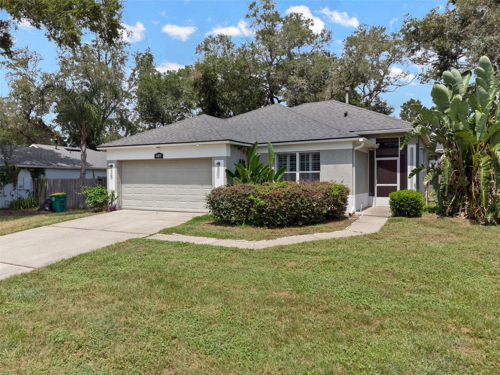 This beautiful single-level stucco home sits on a large lot with mature oak trees & towering tropical plants, which makes the property feel very private.
Inside the front door, you’ll find an open floorplan with tile & laminate floors, crown molding, plantation shutters, updated fixtures and lots of natural light.
The kitchen overlooks the dining area and features 42-inch cabinetry, a pantry and a long breakfast bar with seating for a crowd.
Just steps away, you can enjoy coffee or grill up dinner on the lovely back lanai. In the fenced-in backyard, you can entertain in the large gazebo, with a plenty of yard space for your garden, a playscape, firepit area or future pool. There’s a 10x12 storage shed, too!
Back inside, the primary bedroom boasts vaulted ceilings and an ensuite with a step-in shower and a generous walk-in closet. The guest bedrooms share the updated hallway bathroom. Don’t forget about all the storage in the laundry room/drop zone and the attached 2-car garage.
What a fantastic North DeLand location! You’ll be within 5 minutes of Stetson University, with downtown DeLand's Historic Garden District also just a 5-min drive away. All the shopping & dining options along International Speedway Blvd are also just 5 mins from your front door. Be at the beach in half an hour! Come see this MOVE-IN-READY property in person!