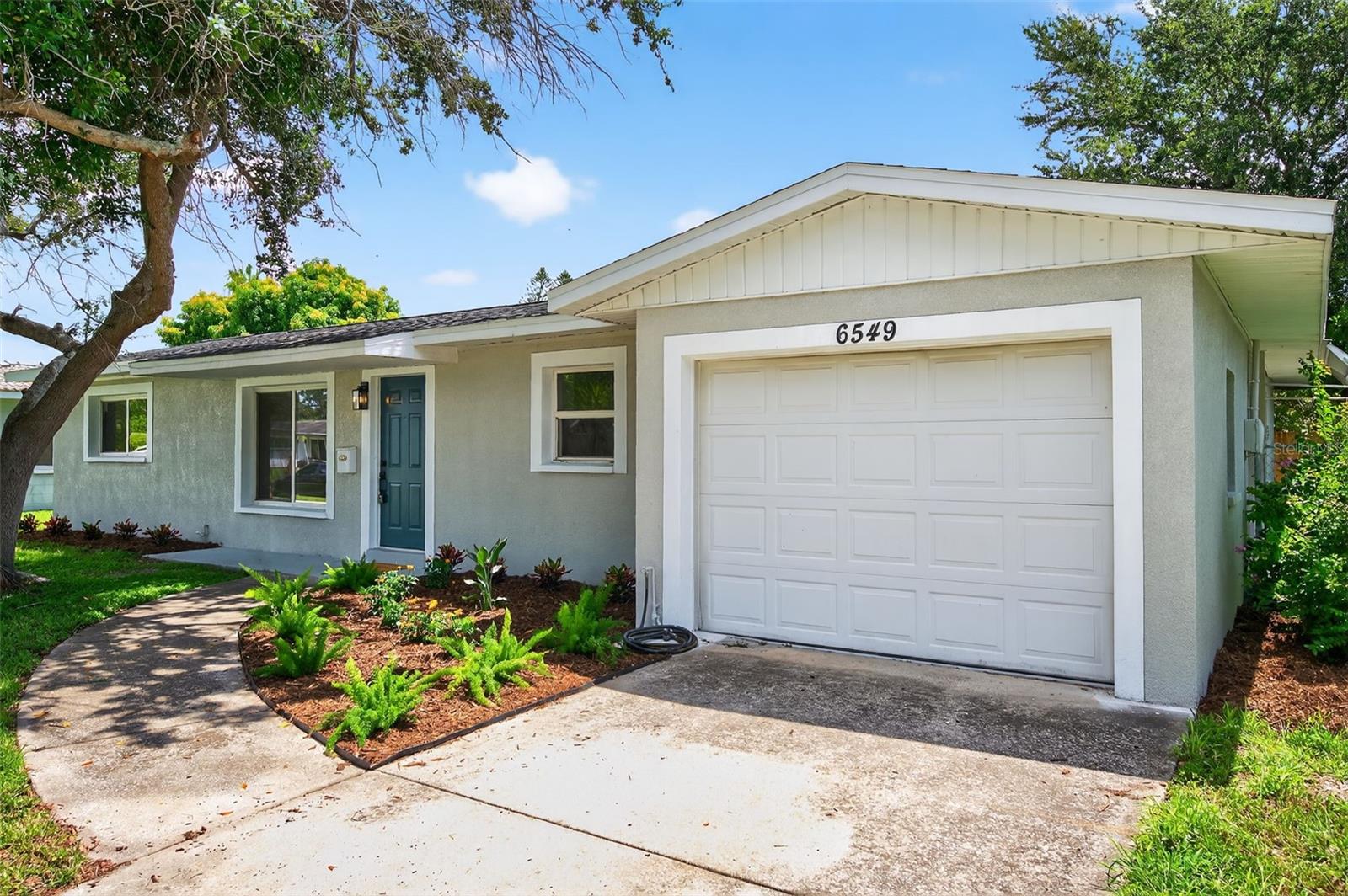 This beautifully and tastefully renovated home is a perfect blend of modern design and timeless charm, nestled in the desirable, well-established Meadow Lawn neighborhood. Importantly, the property is not located in a flood zone, nor did it have damage from the storms in 2024. Upon entry, you're greeted by an open-concept floor plan that flows seamlessly from room to room. The kitchen is a showstopper — fully remodeled with custom soft-close cabinetry, quartz countertops, a stove pot filler, a large island , and brand new stainless steel appliances. A designer tile backsplash and modern lighting complete the look.The primary suite is a tranquil retreat with an en suite bath featuring a walk in shower with frameless glass shower doors. Secondary bedrooms are generously sized with ample closet space, and the additional bathroom has been fully updated with elegant tile work, a modern vanity, and new fixtures. New roof in 2025. New HVAC in 2022. Windows were replaced in 2014. Water heater replaced in 2016. The huge 600+ square foot screened lanai adds additional living and entertaining space.