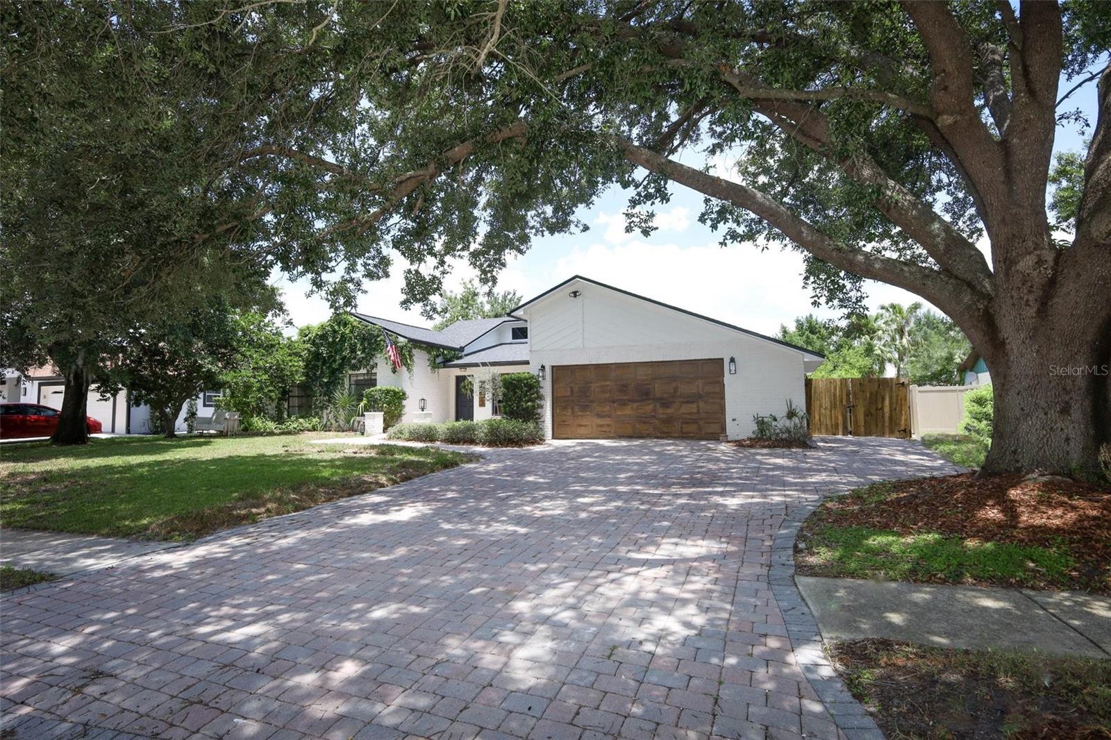 Discover comfort and privacy in this charming and updated 4-bedroom, 2.5-bathroom pool home nestled on a quiet cul-de-sac in the well-established Deerwood neighborhood. With mature landscaping, timeless curb appeal, and a warm community feel, this home offers the perfect blend of everyday living and entertaining potential — all with an incredible low HOA investment of just $105/year. Step into a carpet-free haven featuring stylish wood-look tile and luxury vinyl plank flooring throughout, creating seamless flow and easy maintenance. The spacious open-concept kitchen, dining, and family room is the heart of the home, showcasing natural light, window casings, and a stunning electric fireplace under soaring ceilings. The chef’s kitchen boasts stainless steel appliances, a modern tile backsplash, and a functional island perfect for gathering. Adjacent to the family room, you’ll find an expansive Florida Room — a bonus prep and entertaining space that opens effortlessly to the outdoors. All four bedroom retreats are thoughtfully tucked away in a private wing, offering a peaceful sanctuary apart from social areas. The primary suite is oversized with a walk-in closet and direct pool access through the ensuite bath. Outside, your private, fenced yard opens to a refinished, screen-enclosed saltwater pool (20’x40’, 30,000 gallons) — complete with solar heating to extend the swim season, a deck shower, and a convenient half bath accessible from the patio. The freshly painted exterior and pool deck provides a bright, clean look. Roof (2020) and water heater (2025) ensure peace of mind for years to come. Live just minutes from active community offerings and everyday conveniences. Enjoy public golf and social events at the prestigious Rio Pinar Golf & Country Club, and explore nearby shopping, dining, and entertainment options. Quick access to SR-408 and SR-417 makes commuting a breeze, with proximity to Orlando International Airport (MCO), downtown Orlando, and top-rated higher education like UCF and Valencia College. Health and wellness are within reach with nearby hospitals, and when it’s time for fun, you’re a smooth ride away from Central Florida's world-famous theme parks, attractions, and even the Space Coast and beaches. Schedule your private showing today!