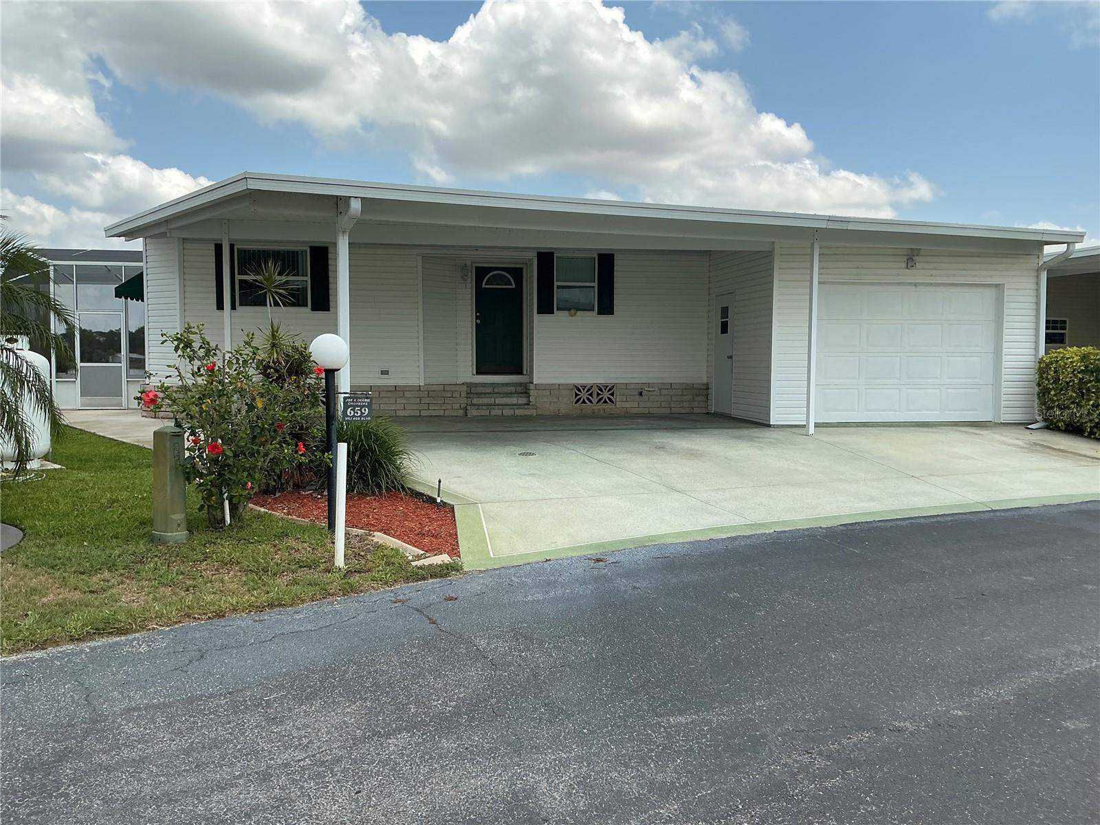 This 2/2 Palm Harbor manufactured home is nestled in a serene setting with beautiful views of the golf course as well as tranquil views of the lake. The home boasts spacious living with the expansive living/dining room with windows across the back to take in the scenic views. There're double doors in the dining room that leads to a screened-in patio where you can enjoy your morning coffee or evening sunsets. Spacious kitchen with updated appliances located near the living area and the front door. The primary bedroom offers generous square footage for arranging furniture, TWO large walk-in closet designed for organization for all your clothing and accessories. The ensuite bathroom is spacious and offers convenience and privacy. The guest room is cozy yet spacious with a window to bring in natural light. The other room located in this area is currently set up as a den/office but could easily add a closet to make it the third bedroom. There's a guest bathroom located nearby to accommodate your guests. The laundry room is functional and spacious, equipped with front load washer & dryer. A separate hallway connects the rooms, creating an easy flow between spaces while providing privacy for the guest area. There's a two-car carport which provides protection from the Florida elements as well as a golf cart shed. There's a Generac generator ensures the home remains powered during electrical outages.
This home is located in central Florida in a 55+, gated community that boasts of ownership pride. From the time you enter the gates, the well-maintained appearance of the community is very evident. The association fee is currently $206 per month, collected twice a year. This includes your lawn mowed & trimmed, basic cable & the removal of garbage. The great news, you own your property so no lot rent! This is a friendly, active community that welcomes new faces.
This home is an exceptional retreat for your retirement, offering golf course living with overall affordability and an opportunity to put your personal touches to make this home yours!