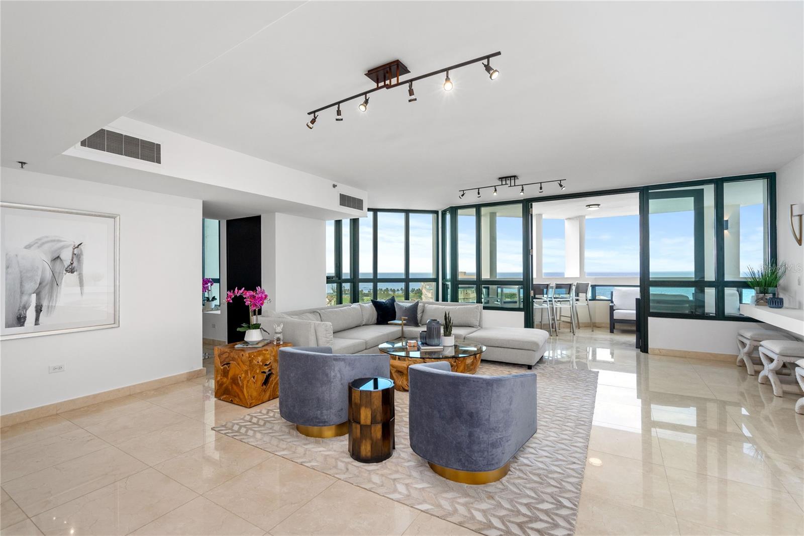 Experience the pinnacle of luxury with this stunning 12th-floor residence in Caribe Plaza, San Juan's premier full-service building. Boasting 4 bedrooms and 4.5 bathrooms, this apartment provides unparalleled comfort and elegance, spread over a spacious floor plan, illuminated by natural light.
The home offers breathtaking panoramic views of the ocean, allowing you to witness Puerto Rico's picturesque sunsets and azure waters right from your living room. Each bedroom offers a serene retreat, complete with private bathrooms, while the primary suite includes a spa-inspired bath for a tranquil sanctuary.
The stylishly appointed chef's kitchen is a culinary dream, offering state-of-the-art appliances and ample storage. The open-concept layout seamlessly flows into the living and dining areas, perfect for entertaining or simply relaxing after a long day.
Living in Caribe Plaza means enjoying the finest amenities, including full-time concierge service, a state-of-the-art gym, and an exclusive resident's lounge. Indulge in the island's luxury living, with easy access to San Juan's vibrant nightlife, world-class dining, and shopping without the traffic. Don't miss this rare opportunity to own a piece of paradise in the heart of the city.