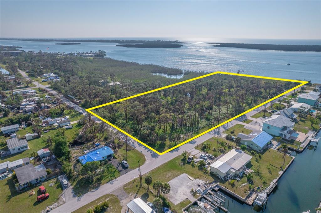 PRIME WATERFRONT MULTIFAMILY Development Opportunity! 6 acres located on Lemon Bay, opposite Stump Pass with direct access to the beaches & pull-up restaurants close to Manasota Key. PRE-PAID IMPACT FEES, zoned RMF 10 & RMF 5, possible 43 units development. NEW SEA WALL, concept plans for condos & tiny homes developments available, as well as Phase 1 due diligence. Multi-access to highways including I-75, and to Punta Gorda & Ft Myers airports. Fast access to SR-41. Located in America's #7 entrepreneurial ecosystem: high growth Charlotte County (tax abatements, expedited permitting, Opportunity Zone: capital gains waivers).