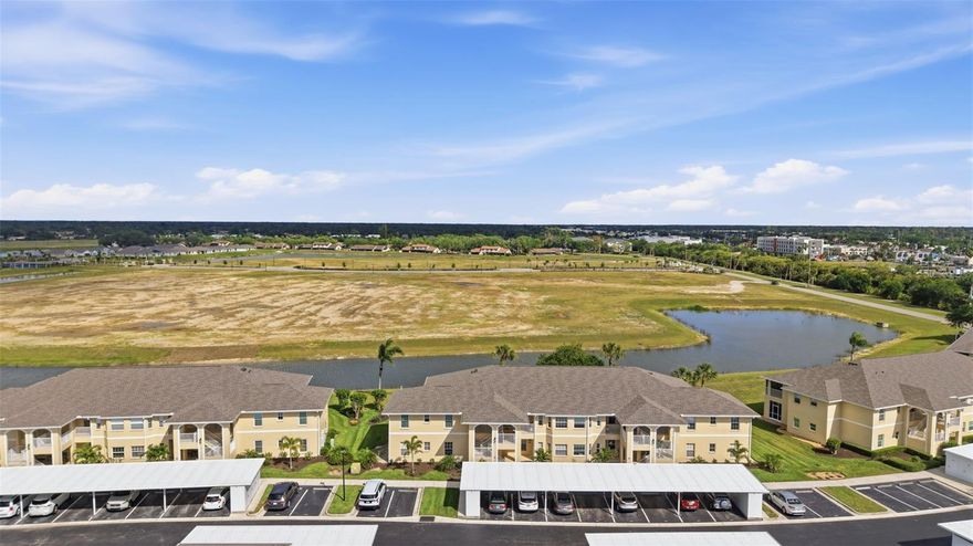 Spacious 3 bedroom, 2 bath condo in a gated community offering peaceful water views and easy, low-maintenance living. This well-designed layout features a bright, open living and dining area with large windows and sliding doors that bring in natural light and showcase the view beyond. The kitchen includes ample cabinet space, updated stainless appliances, and a cozy eat-in area surrounded by windows.

The primary suite offers a walk-in closet and private bath with dual sinks and a walk-in shower. Two additional bedrooms provide flexibility for guests, a home office, or hobby space. Neutral flooring runs throughout, creating a clean and cohesive feel.

Step out to the screened lanai and take in wide water views and open green space—an ideal spot for morning coffee or unwinding at the end of the day. The community itself is well-kept and offers a pool, sidewalks, and a quiet, tucked-away setting.

Additional features include in-unit laundry, hurricane shutters, and a covered carport with assigned parking. Conveniently located near shopping, dining, and everyday essentials, this is an easy option for seasonal or full-time living.