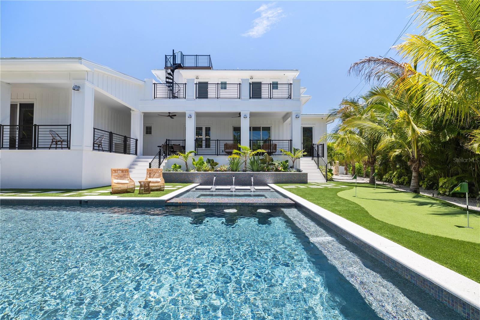 Welcome to this newly built Waterfront Home featuring a spacious 6 bedrooms, 6.5-baths with easy access to Bimini Bay and the Intracoastal Waterway from your private dock equipped with a 10,000 lb. boat lift. Positioned on a large corner lot just minutes from the beach this home is perfect for entertaining with surrounding water views from your private roof top terrace. The gourmet kitchen features a butlers pantry with wine cooler, custom cabinetry, quartz countertops, and high end appliances. The main floor master bedroom features a private patio leading to the pool plus walk-in closet. The spa-like master bathroom centers around your stand-alone tub and frameless glass shower with dual his and her vanities. All bedrooms are en suite with each bathroom having its own unique tile, countertop and vanity selection. A smart home system is included for your tv, speakers, and cameras. The private backyard features a large heated saltwater pool and spa with floating steps surrounded by lush landscaping and shell stone which also covers the lanai. Call today for your private showing!