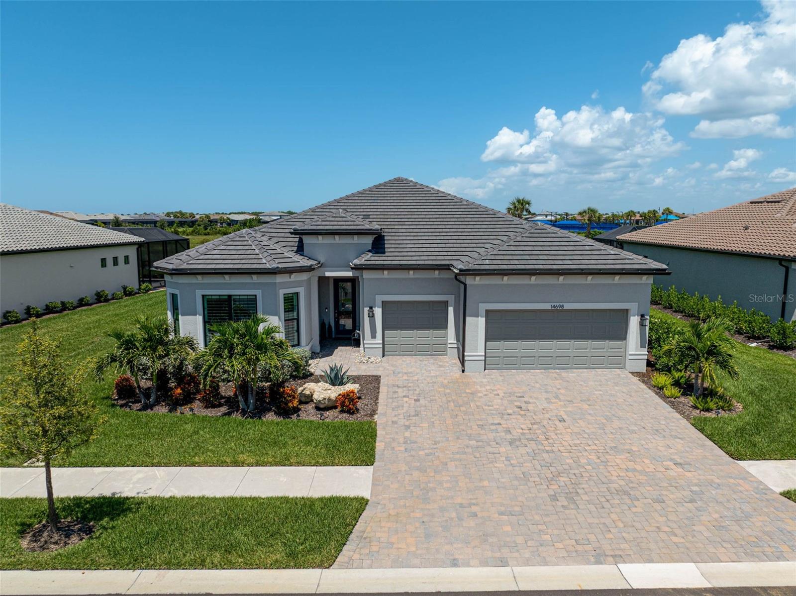 Resort Luxury
This stunning executive home in Palmer Ranch’s newest gated resort community, offering 3,028 square feet of luxury living with exceptional upgrades and custom features throughout. The open-concept layout is perfect for entertaining, featuring abundant natural light and nature preserve views, all set on an 80.75-foot wide premium lot that ensures privacy with ample space between neighboring homes. Inside, you’ll find soaring 10½-foot ceilings, impact windows and doors, 2’x2’ sealed ceramic tile flooring, and plantation shutters throughout. Designer light fixtures add an elegant touch, while the oversized fireplace in the family room creates a cozy ambiance. The gourmet kitchen is a chef’s dream, equipped with a 10-foot island, a 5-burner gas cooktop, beverage fridge, wine storage, soft-close cabinets, pull-out drawers, and undercabinet lighting. The owner’s suite is a true retreat, featuring a tray ceiling, custom wall features, ceiling fan, and dual custom closets with three levels of storage. Outside, the custom outdoor kitchen is designed for al fresco dining with a versatile stainless steel grill, stainless vent hood, and full-wall porcelain backsplash. The family-sized pool (15x35) with a sun deck and a 6-person heated spa provides the perfect space to relax, while the travertine pool deck and picture-frame pool cage complete the outdoor living experience. The finished 3-car garage includes a 4-foot extension, insulated doors, sealed floors, overhead storage, and custom-painted walls.
The community offers resort-style amenities including a pool with a splash pad, a restaurant bar and grill, pickleball, tennis, and bocce ball courts, as well as a gym, game room, playground, and dog park. Direct access to the Legacy Trail for biking and running adds to the lifestyle options. The area is also home to an active social calendar with clubs and events. Just minutes from Nokomis Beach, 15 minutes from shopping and entertainment in downtown Sarasota, and close to Sarasota Memorial Hospital, this location truly offers the best of Florida living. Don’t miss the chance to own this beautifully upgraded home with unparalleled amenities and a prime location—schedule your showing today, as it won’t last long!