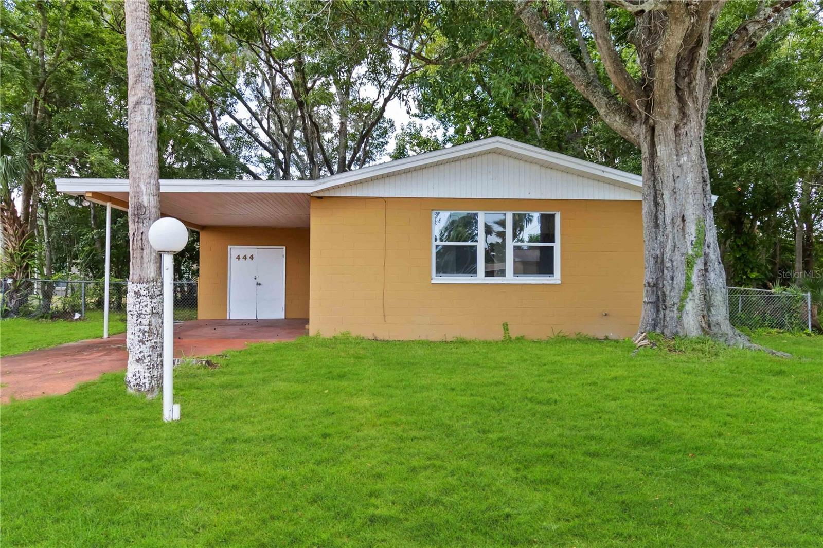 Recently updated with a new roof, new flooring, new windows, new doors, and fresh interior paint, this 3-bedroom, 1.5-bathroom home is ready for you. Inside, you'll find an open living and dining area, a kitchen with brand new appliances, and a separate laundry room with washer and dryer hookups. The spacious primary bedroom offers two closets, while the additional bedrooms provide flexibility. A full bathroom with a shower and a convenient half bath add everyday ease. Outside, enjoy a fenced backyard and a covered carport with one parking space. With all the major updates already done, this move-in ready home is the perfect opportunity to settle in and start making it your own—just minutes from shopping, the beach, and I-4/I-95 for easy access wherever you need to go.