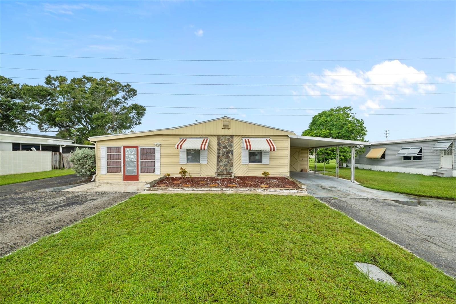 Welcome to your perfect Florida retreat! This well-maintained manufactured home is located in a peaceful community in beautiful Clearwater — only a short drive (10–15 minutes) from the soft white sands of Clearwater Beach. Offering 3 bedrooms, 2 bathrooms, and a spacious open-concept living area, this home combines comfort and convenience. Enjoy a bright kitchen with skylight allowing plenty of natural light. Enjoy the convenience of updated bathrooms, hard floor throughout and covered parking. For those that work from home there is flex space that can be used as an office, playroom, or living space. There is plenty of storage including the large garage which houses the washer and dryer. Whether you're looking to downsize, retire, or invest, this affordable home offers the opportunity you’ve been looking for. No lot rent, you own the land.
