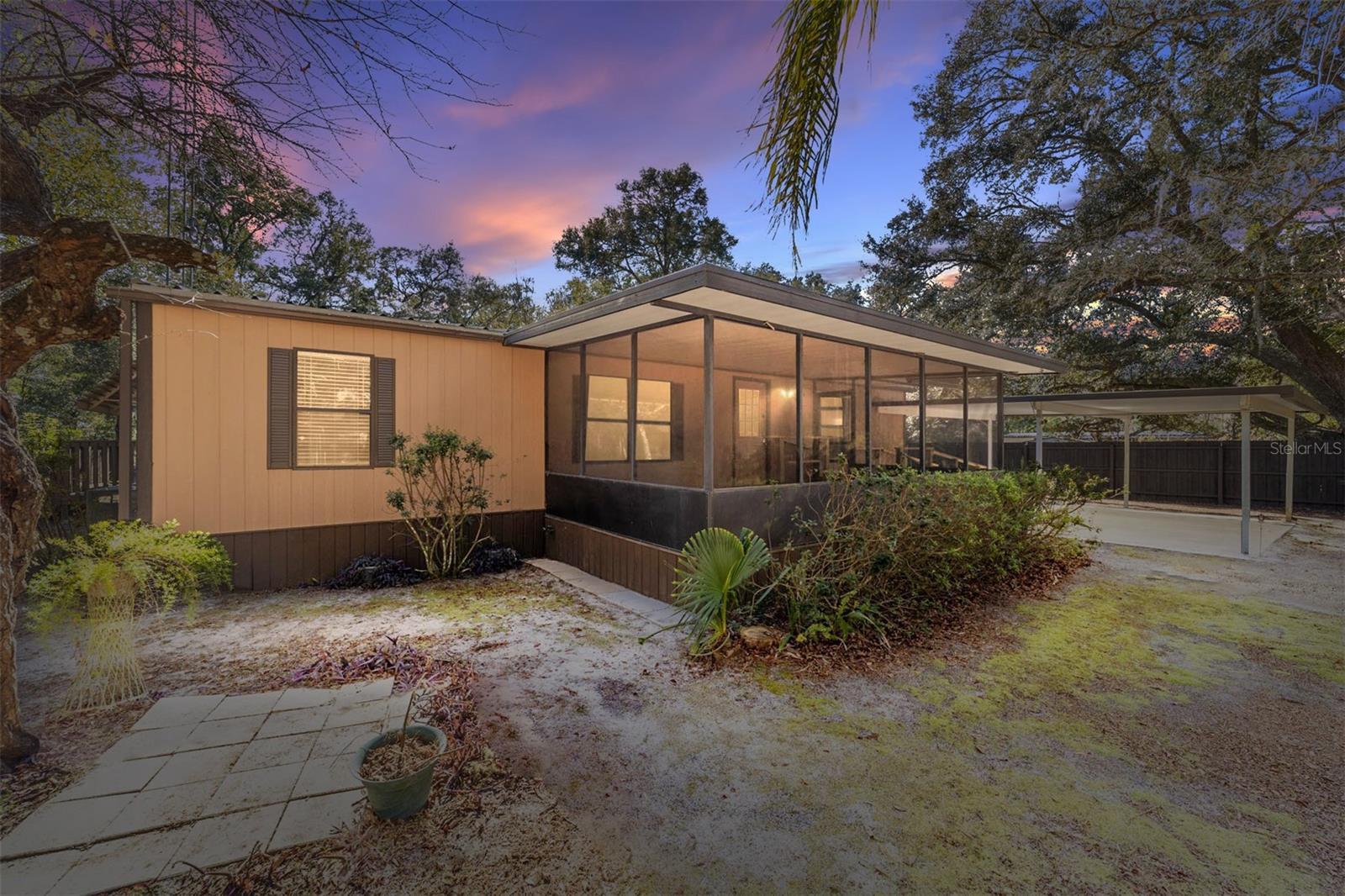 Your Country Oasis Awaits!
Nestled on an expansive lot, this charming 3-bedroom, 2-bath home offers the ultimate blend of peaceful country living and convenience. Perfect for those who appreciate both privacy and functionality, this property features multiple outbuildings for storage, workshops, and outdoor activities.
Relax in the serene bromeliad gardens beneath a majestic oak canopy, or unwind around the fire pit. Enjoy the above-ground pool, screened in under a durable metal roof, or easily convert it back to RV storage with a 30-amp hookup. A separate shed offers additional storage, while a concrete-floored workshop provides the perfect space for hobbyists, makers, or mechanics. There’s even a covered area for your boat and a two-car carport at the front of the home.
The home itself is move-in ready with recent upgrades including freshly painted rooms, a metal roof (installed about 5 years ago), new AC, and a drain field (replaced in 2020). The well tank was also updated just three years ago. With laminate flooring throughout and a large addition for a spacious family room or den, there’s plenty of space to spread out. A bonus room off the family room is ideal for indoor hobbies, an office, or a playroom.
Accessibility is key with a large, screened-in front porch, easily accessible via a ramp.
Just minutes from Silver Springs State Park, renowned for its glass-bottom boats and kayaking, and the vast Ocala National Forest, with over 387,000 acres to explore. You’re close enough to Ocala for shopping and conveniences, yet far enough away to enjoy peace and quiet on a road where neighbors are friends.
This property is ready for all your outdoor adventures and is waiting for you to make it your own. Don’t miss out on this incredible country retreat!