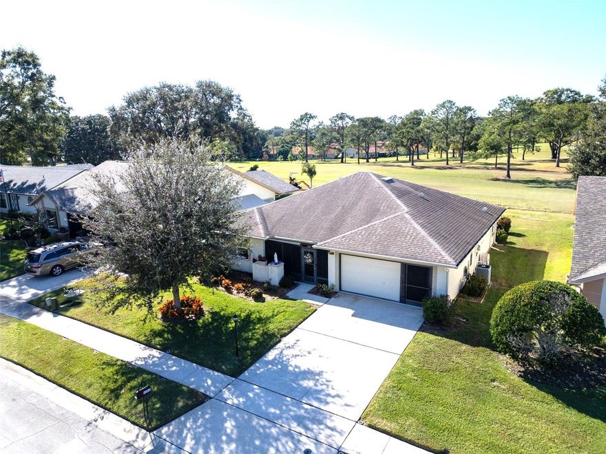 This well-appointed 2-bedroom, 2-bathroom, 2-car garage home is situated on the White course, hole #2, in the desirable Highland Lakes 55+ community. Featuring a spacious open floor plan and numerous updates, the property is move-in ready. The interior showcases laminate flooring, contemporary baseboards, crown molding throughout and plantation shutters on all the windows. The kitchen is equipped with granite countertops, wood cabinetry, and newer stainless steel Whirlpool appliances. An enclosed sunroom spans the width of the house with sweeping views of the golf course, modern ceiling fans, a vented portable air conditioning system, and pull-down shades. Adjacent to the sunroom is a private patio area, ideal for enjoying morning coffee or relaxing with views of the Florida sunset. The double garage provides ample parking plus space for a golf cart. A transferable 4-point inspection has been completed for your convenience. The HVAC system is six years old, the roof was replaced eight years ago, and a new hot water heater was installed in November 2025.
Residents of Highland Lakes enjoy exceptional amenities, including three nine-hole golf courses, a main clubhouse with a seasonally temperature-controlled pool, pickleball, tennis, ceramics and woodworking facilities, as well as a lakefront clubhouse featuring a pool, pontoon boats, fishing deck, and RV/boat storage. The low monthly fee of $164 grants access to all amenities. Early viewing is recommended.