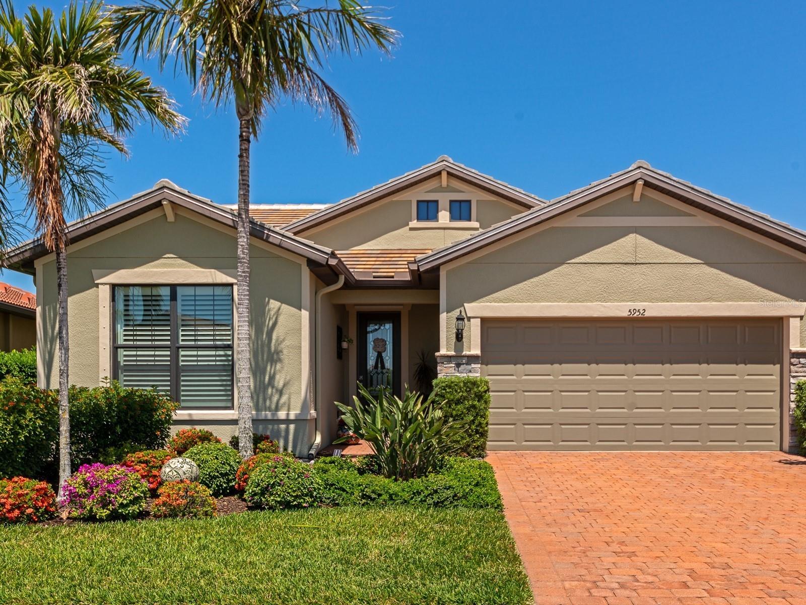 Experience ultimate comfort and convenience with this maintenance-free single-family home in a gated community. Built in 2016, it features the sought-after Pulte-Divosta Abbeyville FLEX floor plan with 2-3 bedrooms and 2 baths. Upgraded with a custom Crystalline front door, the foyer showcases hardwood flooring that flows seamlessly into the flex room, as well as the front bedroom and primary suite. Crown molding and plantation shutters are striking and enhance the elegance of nearly every room in the home. As you step through the arched entryway, you're welcomed into the great room, where tiled flooring adds a touch of sophistication to the space. At the heart of the open kitchen is a granite center island that not only offers ample storage but invites a gathering with bar seating. The essential appliances, along with a high-efficiency natural gas range, are included. This space also has wood cabinetry, a spacious built-in pantry, and stylish pendant lighting, all designed to elevate your culinary experience. Combined with the living and dining rooms featuring sliding glass doors that lead to a covered, and screened lanai with paver bricks. The primary suite serves as a private retreat located at the back of the home. It has a personal bathroom equipped with granite countertops, dual sinks, high-quality cabinetry, a water closet, and a walk-in shower adorned with tile and a glass door. The laundry room is conveniently located nearby and includes a walk-in storage area. Additional storage is available in the drop-zone ready entry from the two-car garage. Lovely curb appeal starts with a tile roof, a brick paver driveway, and a lush, maintenance-free lawn and landscape that invites you in. Discover Sandhill Preserve, where a stunning resort-style amenity center awaits you, complete with inviting sidewalks that wind through the beautifully designed grounds. Residents can enjoy a welcoming clubhouse, a fitness center, community spaces, ample patio seating, a firepit, barbecue areas, a spacious cabana, as well as a swimming pool and spa. The community also includes tennis courts and a central postal box. This is a gated community in Palmer Ranch with no CDD fees. Situated within an A-rated school district, in one of the best locations in Sarasota, with easy access to the Legacy Trail, top-notch golf courses, I-75, and a wide variety of shopping and dining choices. Plus, the gorgeous white sandy beaches of Siesta Key are just minutes away!