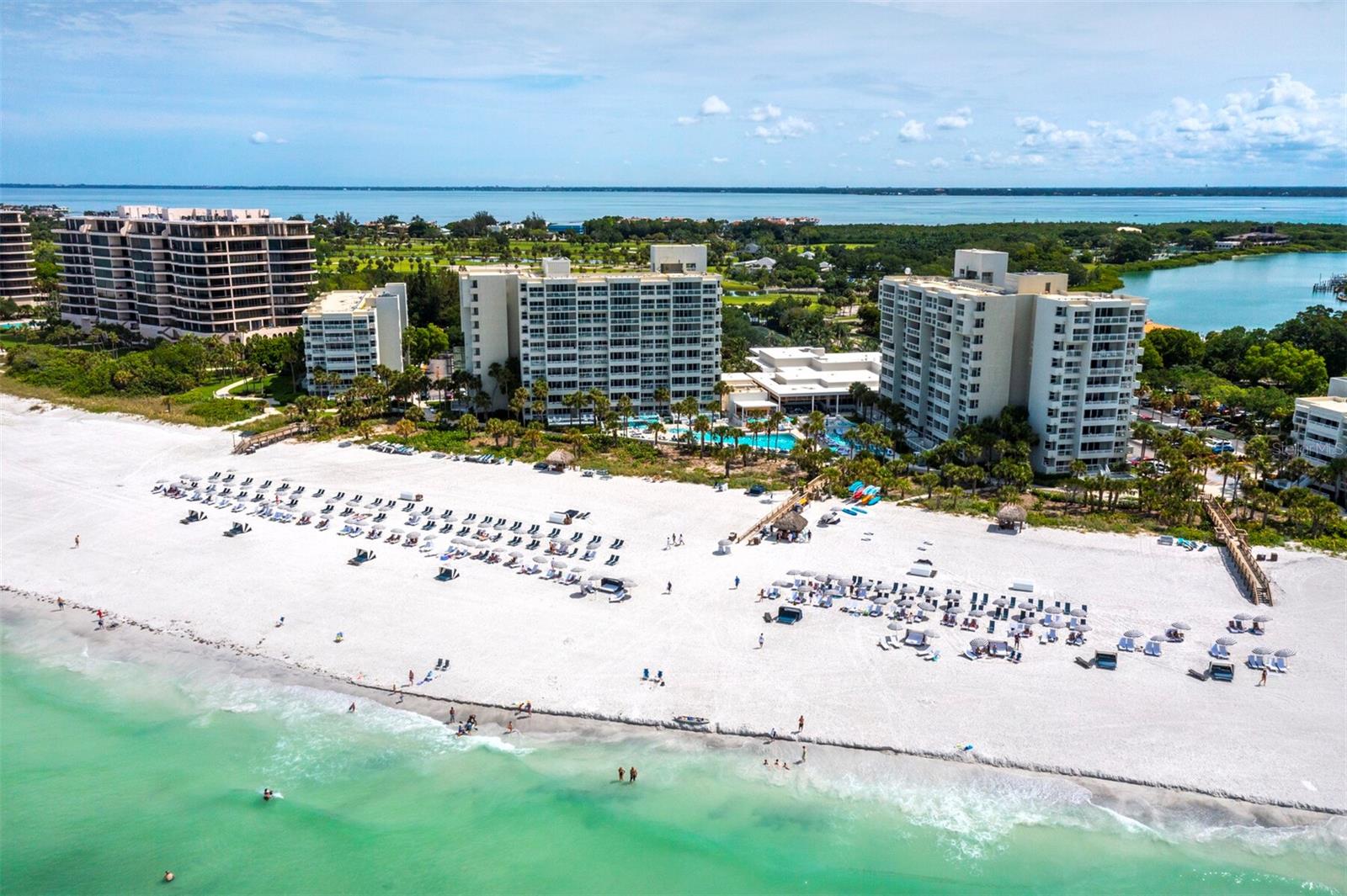 Located behind the gates of the highly desirable Longboat Key Club, this 1BR/1BA Club Suite at Inn on the Beach offers a unique opportunity to own within the prestigious Longboat Key Club Resort. Spanning 650 sq. ft., this residence provides both convenience and privacy, with an expansive covered terrace offering peaceful Gulf views while keeping you close to every amenity. Completely renovated and meticulously styled, the interior pairs warm wood accents with neutral tones, complemented by faux wood tile floors flowing throughout. Dual sliders frame shimmering Gulf waters and invite natural light into the living space. The kitchen is a standout, with stone countertops, harmonizing cabinetry with glass panel accents and a colorful tile backsplash that adds just the right touch of vibrancy. Off the bedroom space, a beautifully updated bath features all-white cabinetry, a separate water closet and a glass walk-in shower with striking tilework. For added ease, in-unit laundry utilities are included. This unit participates in the Resort Rental Program and has a healthy rental history, with nightly rentals allowed, making it both an enjoyable retreat and a strong investment. As an owner, you’ll have access to the exclusive amenities of the 410-acre Longboat Key Club, including 45 holes of championship golf, 20 Har-Tru tennis courts at the award-winning Tennis Gardens, a full-service marina, private Gulf-front beach with umbrellas and attendant service, a world-class fitness and wellness center, spa and five private dining options. Recently renovated guest services, dining areas, and resort amenities have elevated the experience even further, earning accolades such as the AAA Four-Diamond Award and recognition from Condé Nast Traveler as a Top Florida Resort.