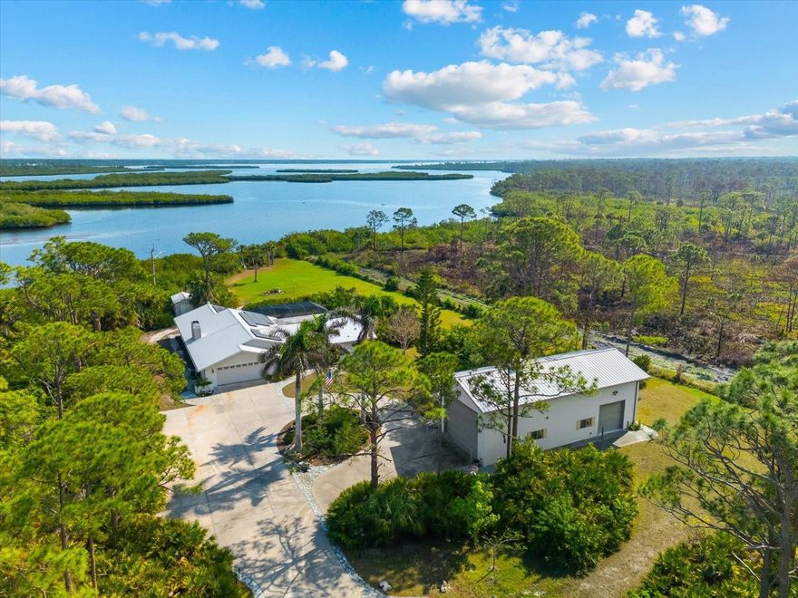 Nestled in the tranquil and sought-after Myakka Country, this 4-bedroom, 2-bathroom waterfront home spans 2,490 square feet and sits on 1.7 acres of lush land. With a private boat dock, it’s the perfect retreat for those who love waterfront living, privacy and outdoor adventure.
This home offers a versatile, open floor plan with two distinct living areas. Upon entry, you are greeted by the formal living and dining rooms, which flow seamlessly into the pool area through large sliding glass pocket doors. Beyond the dining room, the spacious kitchen features a massive island that overlooks the family room, where a charming fireplace creates a cozy retreat. To the right of the kitchen, the dinette area and a large walk-in pantry provide loads of  storage, keeping your kitchen organized and clutter-free. The dinette area also offers direct access to the pool.  The primary bedroom is located on one side of the house, while the three additional bedrooms are thoughtfully positioned on the opposite side for enhanced privacy. Bedrooms 3 and 4 are separated with a bifold closet door. You could leave it as is to make one very large room/office space or if you choose, you could close it off completely.
The pool area is fully enclosed with a newer pool cage (installed in 2022), offering generous covered space ideal for entertaining guests. The metal roof, installed in 2019, is complemented by solar panels, providing both energy efficiency and sustainability.
This property includes a spacious 1,320-square-foot garage/barn, perfect for storing your RV, boat, cars, or other recreational vehicles, with plenty of room left for additional storage. The home also features an attached 2-car garage, adding even more convenience for everyday use.
The south side of the expansive lot is bordered by Myakka State Forest,  which contains over 40 miles of trails that are open to hiking, biking and equestrian activities- perfect for nature lovers.
This home offers the best of both worlds: seclusion in a peaceful, waterfront setting with easy access to I75 and all the amenities of Wellen Park and nearby beaches. Whether you’re seeking a full-time residence or a seasonal getaway, this property provides everything needed for the ultimate waterfront lifestyle.  The home will also come with a 1 year home warranty!   Book your showing today!
