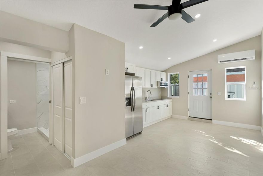 Be the first to live in this completely brand-new efficiency studio, thoughtfully finished with modern, clean-lined design and easy-care surfaces throughout. The open studio layout offers a bright living/sleeping area complemented by a full closet for added storage and organization. Enjoy efficient comfort year-round with a dedicated mini-split system. The kitchen is beautifully appointed with quartz countertops, white shaker cabinetry, and an induction cooktop, along with a full-size refrigerator and ample cabinet space for everyday essentials. Please note there is no oven and no dishwasher. The bathroom is finished in a contemporary style and the home features ceramic tile flooring throughout for a sleek look and low-maintenance living. This is a rare opportunity to lease a truly new, move-in ready studio with high-end finishes in a compact, functional space.