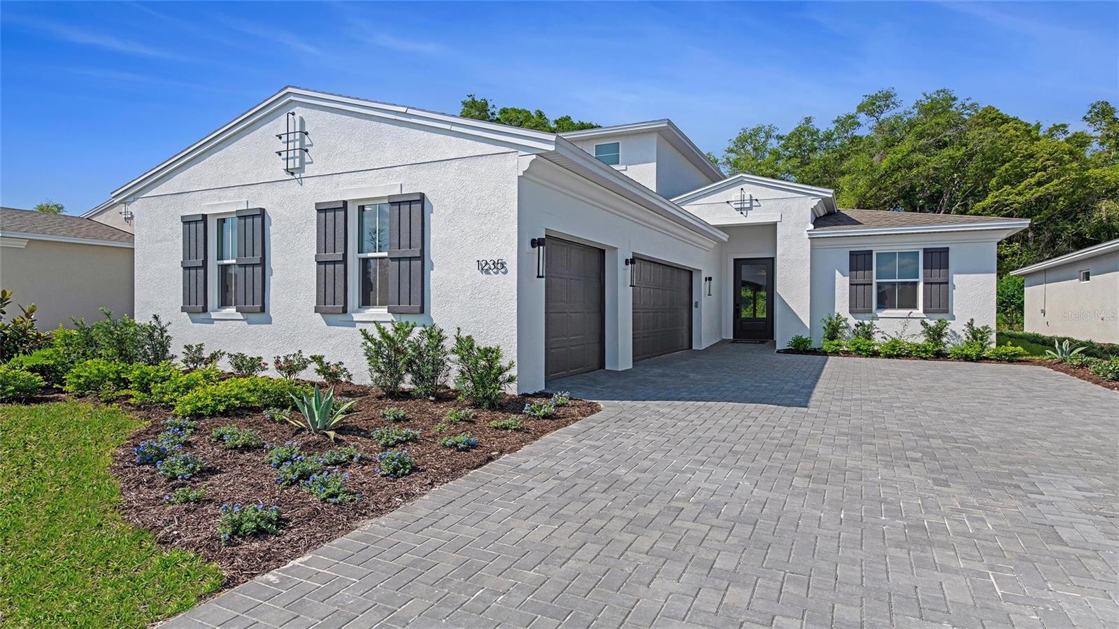 **New Construction** Step into this beautifully designed Laura model featuring 3-Bedrooms, 3-Bath, Flex Room, and complete with an expansive Bonus Room featuring its own bathroom and walk-in closet—ideal for guests, or a media room. The 3-car garage offers ample room for vehicles, storage, and hobbies. Outdoor living is a breeze with a private lanai framed by a 5-foot privacy wall, plus an extra gas drop perfect for your custom fire pit or gas grill setup. Hosting is easy with pre-wiring for a summer kitchen and full gas/plumbing rough-ins in place. Inside, the gourmet kitchen is as functional as it is stylish, featuring a split cabinet and appliance configuration. Level 2 cabinetry pairs seamlessly with sleek quartz countertops, a GE 30" cooktop, 30" under-cabinet hood, and specialized cooktop cabinet drawers—all thoughtfully arranged for optimized flow and convenience. Durable and elegant wood laminate flooring runs throughout the home, adding a warm, modern touch.