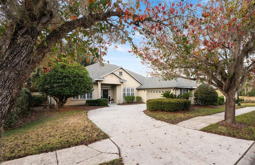 Welcome home to this stunning and spacious former Parade Home, situated on a manor lot in the highly desirable Longleaf community. Thoughtfully designed, this open-concept home offers over 2,900 square feet of beautifully appointed living space, featuring 10-foot ceilings, crown molding, plantation shutters, and vinyl plank flooring throughout the main living areas and bedrooms. At the heart of the home, the expansive eat-in kitchen is designed for both everyday living and effortless entertaining. It boasts abundant cabinetry and generous countertop space, stainless steel appliances, a tile backsplash, pantry storage, a prep island, and two breakfast bar areas that provide ample seating. The kitchen flows seamlessly into the main living spaces, enhancing the home’s open and welcoming feel. The well-designed 4-bedroom, 3-bath, three-way split floor plan offers exceptional flexibility and privacy. The primary suite serves as a true retreat with two walk-in closets and a spacious ensuite bath featuring dual vanities and a large garden tub. On the opposite side of the home, two guest bedrooms share a full bathroom, while the fourth bedroom and third bath provide the perfect setup for guests, an office suite, or additional flex space. The home’s layout also includes a formal dining area and a versatile bonus room with a gas fireplace—ideal for a home office, library, or flex room. Off the main living area, French doors lead to a large screened, covered back porch, creating an ideal space for relaxing or entertaining while enjoying the outdoor setting. Additional highlights include an oversized laundry room with built-in cabinetry and dedicated hanging and folding areas,  pull-down attic storage in the garage, and the roof replaced in 2021. The HOA provides front lawn service, and enjoy the resort style community amenities including a clubhouse, 24 hour fitness center, beach entry pool, playground, tennis courts, and a basketball court. Conveniently located near I-75, UF, UF Health, VA, Celebration Point and Butler Plaza. Schedule your private tour today!