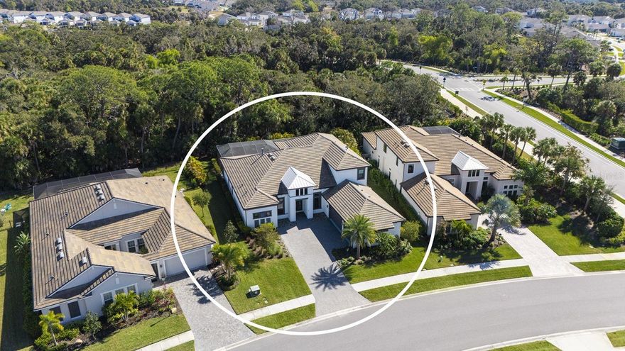 Experience elevated living in the highly sought-after Skye Ranch community of Sarasota. Perfectly positioned on Starry Night Avenue, this expanded Beacon Model offers an impressive 4,877 square feet under air across two thoughtfully designed levels, showcasing refined finishes, extensive upgrades, and exceptional attention to detail throughout. Meticulously maintained and beautifully appointed, this four-bedroom residence features four full baths and two half baths, including three private ensuite bedrooms and a fourth bedroom with Jack-and-Jill bath access. The main living areas are enhanced by soaring ceilings, elegant flooring, and expansive open spaces designed for both everyday comfort and effortless entertaining. At the heart of the home, the gourmet kitchen is a culinary showpiece, appointed with a Monogram six-burner gas range top with pot filler, double dishwashers, a separate beverage refrigerator with pass-through to the formal dining room, a generous quartz-topped island with touchless faucet, walk-in pantry, and a casual dining area overlooking the stunning outdoor living space. The main level also offers a private office and dedicated media room, providing flexibility for work, relaxation, or recreation.  The spacious primary suite provides the perfect retreat to unwind, offering direct access to the lanai and pool area.  Your private retreat area is complimented by two custom walk-in closets and a spa-inspired bath designed for relaxation.  Upstairs, the second level is ideal for guests or multigenerational living, featuring a spacious bonus room with wet bar, beverage refrigerator, dishwasher, half bath, and a private ensuite bedroom. Outdoor living is truly resort-inspired. The expansive lanai with travertine flooring frames a graciously sized pool and spa with built-in waterfall, firepit, and sunshelf. A fully equipped summer kitchen and serene preserve views create a private, tranquil setting perfect for entertaining or relaxing year-round. Additional highlights include a spacious laundry room and a three-car garage offering ample storage. Ideally located near The HUB Amenity Center and the new Skye Ranch School, residents enjoy access to exceptional community amenities including a resort-style pool, fitness center, clubhouse, café, dog park, scenic trails, sports courts, playgrounds, and a vibrant calendar of events. Convenient to I-75, shopping, dining, and Sarasota’s renowned Gulf Coast beaches. A remarkable opportunity to embrace refined Florida living in one of Sarasota’s most desirable communities.