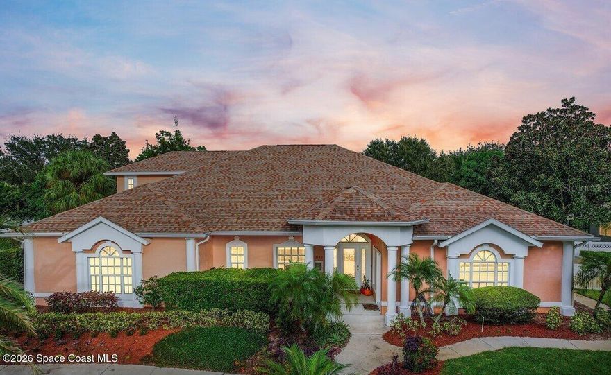 Set on a private ½-acre estate between the rivers in South Merritt Island, this light-filled coastal residence offers refined luxury living designed for entertaining & elegance. Arrive via a sweeping circular drive & step into open spaces enhanced by stunning 3' x 3' polished porcelain tile. Featuring 5 bedrooms, 3.5 baths, & spacious upstairs flex room ideal as a 6th bedroom, executive office, or media room. The private primary wing includes an adjoining flex space perfect for a nursery, dressing room, or study. The showstopping chef's kitchen is the heart of the home, appointed with SS appliances, double ovens, double sinks, a professional-grade cooktop, an impressive 9-ft island, quartz tops, custom backsplash, a Butler's pantry, and maple cabinetry. Outdoor living shines with an oversized screened lanai, summer kitchen, solar-heated pool, outdoor shower, fenced yard & lush fruit trees. Oversized garage, newer roof, & updated systems complete this exceptional offering.