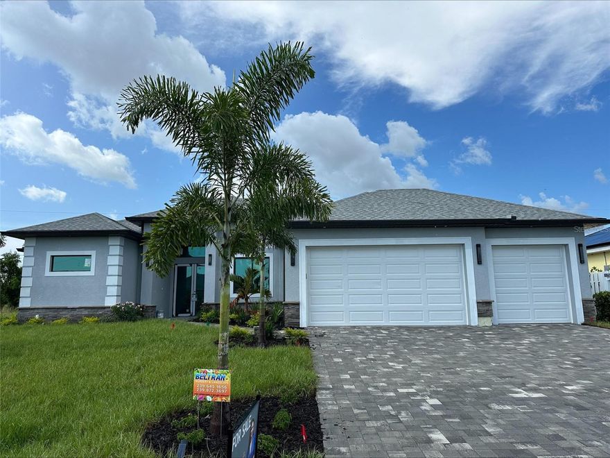 This stunning home, soon to be completed in the heart of Cape Coral, offers a rare opportunity to own a brand-new, custom-designed residence with all the modern comforts. Situated on a generous 10,019 sq. ft. lot, this property features a spacious open-concept design where the kitchen, dining, and living areas flow seamlessly together—creating an inviting space for both everyday living and entertaining.

High ceilings and an abundance of windows fill the interior with natural light, enhancing the sense of openness and elegance. The chef-inspired kitchen is a dream come true, perfect for hosting guests or preparing daily meals in style.
The luxurious primary suite includes not one, but two walk-in closets for his and hers, along with a stunning walk-in shower that is sure to impress.
Outdoors, the home is designed to embrace Florida’s tropical lifestyle, complete with a spectacular pool for year-round enjoyment and a fully equipped outdoor kitchen. The oversized three-car garage provides ample storage and parking for all your needs.
Located in one of Cape Coral’s most desirable neighborhoods, this is truly a property not to be missed! Don’t wait—secure your dream home before it’s finished!