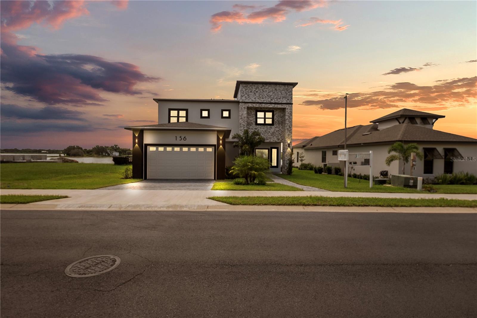 Experience lakefront luxury at its finest in this brand-new, architect-designed residence located in the prestigious, gated community of Water Ridge. This bold and sophisticated home features 4 full ensuite bedrooms, 1 additional full bath, a stylish powder room, a private home office, and an elegant glass-enclosed wine room, all crafted with impeccable attention to detail.
The floating glass staircase, soaring ceilings, and sleek finishes create a commanding presence, while two of the suites offer private balconies with tranquil views. The covered outdoor living area is ideal for entertaining or relaxing in style, with pre-installation for a custom pool and summer kitchen.
With space to build a private dock in front of the home, and access to the community’s exclusive dock and boat ramp, this property is a dream for those who love boating and waterfront living.
The state-of-the-art kitchen is equipped with smart, WiFi-enabled appliances, perfect for modern living. Whether entertaining guests or enjoying a quiet evening at home, every corner of this residence exudes elegance and innovation.
Located in Water Ridge, residents enjoy:
Two resort-style pools + lap pool
Four lighted tennis courts
Private boat/RV storage
Scenic nature trails and a recreation field
Modern fitness center with wellness classes
Gated privacy with convenient access to major highways, upscale dining, and shopping
This home redefines Florida luxury living, refined, rare, and ready for you.