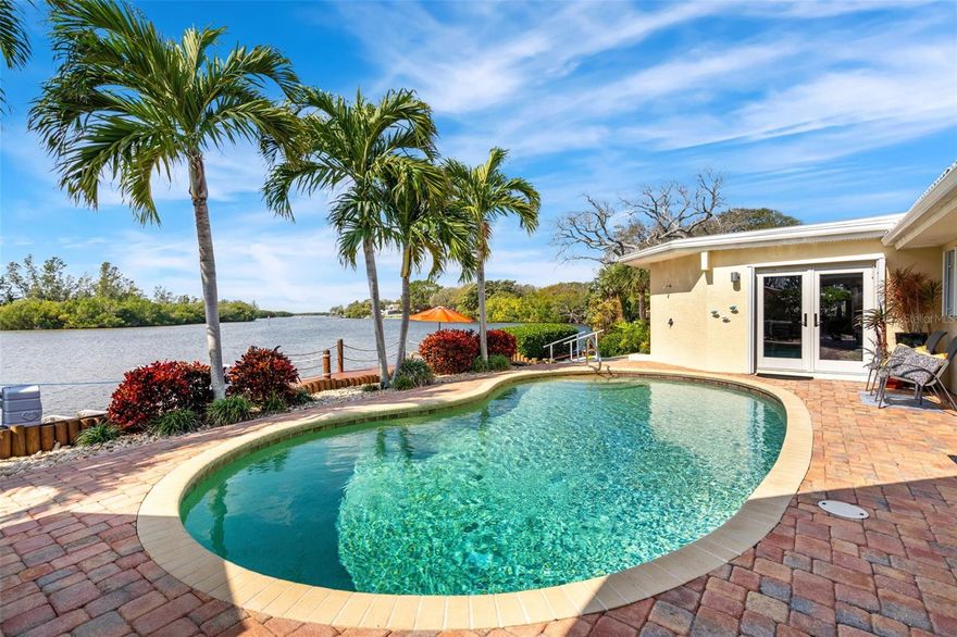 Welcome to waterfront luxury in this stunning one-story, 4 bedroom, 3.5 bath Cocoa Beach pool home, offering breath-taking views of the Banana River and Thousand Islands. Enter through the stainless steel front door and be amazed with the immense open room featuring a window-wall overlooking the River and large dock with 2 boat lifts. Inside you will find 2 comfortable seating areas, a dining area, and a large well-planned chef's kitchen providing generous counters, 2 sinks, sleek cabinetry & SS appliances, including a gas range. A hallway leads you to the addition, completed in 2012, where you will find a giant primary bedroom featuring a window-wall with River views and covered back patio. Inside high ceilings, seating area and a kitchenette, complete with counter space, sink, cabinetry and refrigerator. Adjoining is a full-room closet, complete with laundry area, washer & dryer, plus a primary bath with soaking tub and separate shower with full-body jets.