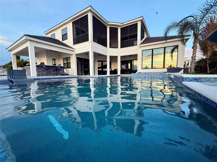 Under contract-accepting backup offers. ***MARKET ADJUSTMENT*** MOTIVATED SELLER!!!  A true BOATERS PARADISE!!!  Don't miss out on this beautiful, custom waterfront home perched on the Manatee River with captivating sunsets and expansive water views!  The home offers unrivaled waterfront luxury and seamless indoor-outdoor living.  The generous-sized modern pool (6' deep with sun shelf, waterfall, 2 fire bowls), 6-person spa, oversized sun deck and outdoor kitchen (equipped with grill, beverage refrigerator, ice maker, sink, & storage) is ready to host all the family parties.  The dock includes LED lighting, potable water, electrical outlets, and 2 lifts, one 20k for your boat and one 10k platform lift for dual personal watercraft.

This stunning home offers 5 generously sized bedrooms with STORAGE GALORE, 4 full and 1 half bath, 3 living / entertainment areas, a dream kitchen with breakfast bar and expansive island, formal dining room, separate office, and oversized 3-car garage (additional 10' in depth and 9' doors) and driveway for ample storage and parking.  The primary bedroom is an owner's retreat, with dry bar, 2 walk-in closets with custom shelving and 2 additional built-in closets for abundant storage and organization.  The primary bathroom offers maximum relaxation with its generously sized free-standing tub and a shower with 3 shower heads and a Moen Spa system with 4 body jets.  This home includes allocated space for a residential elevator.

The Reserve at Harbour Walk community is a boater's paradise with direct access to the Gulf of America and Tampa Bay.  The neighborhood amenities include a kayak launch/storage, tennis courts, and a playground.  The community is also in close proximity to I-75, UTC Mall, diverse restaurants, shopping pristine beaches, and 3 major airports.