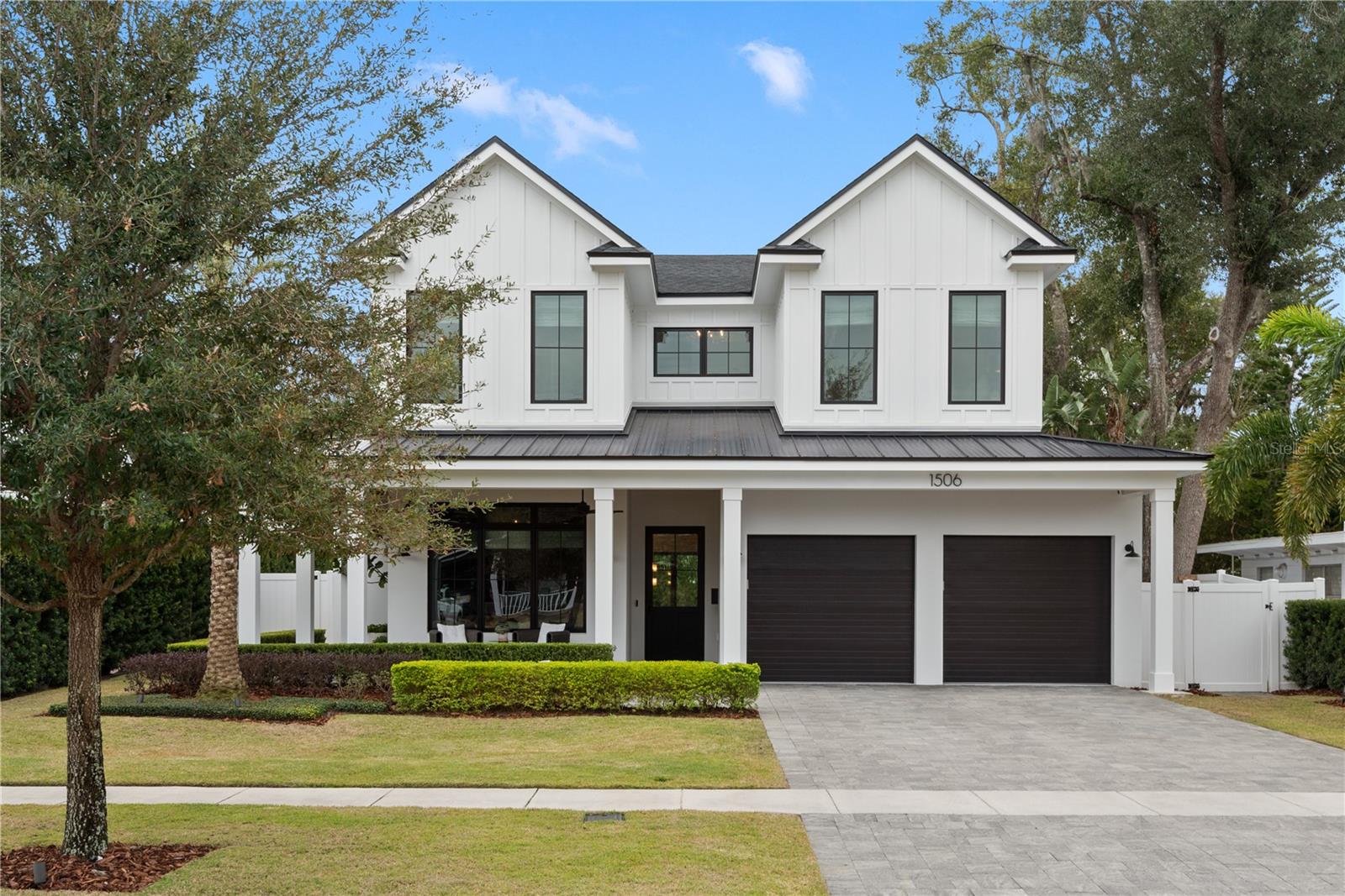 In one of Winter Parks desired neighborhoods, this exquisite Bates Custom Homes house is a three-year-old modern farmhouse that offers the ideal blend of style, luxury and comfort. With five spacious bedrooms, a creative hub and 4.5 beautifully appointed baths, this home is designed for relaxed living and elegant entertaining. The primary suite is downstairs and boasts large windows and a spa-like bath with dual vanities, a soaking tub, a walk-in shower and a custom walk-in closet. An additional four bedrooms are upstairs. The heart of the home is the open-concept kitchen, featuring top-of-the-line appliances like Wolf and Sub-Zero, that make cooking a pleasure. Adjacent to the kitchen, you'll find a light-filled eating area and cozy living space, ideal for family gatherings while turning the surround sound on listening to your favorite tunes or watching your favorite movie. A thoughtfully designed office provides the space for remote work or study. Step outside to your own private oasis, where a charming veranda overlooks a sparkling heated pool and spa, and a fully equipped cabana house. Complete with a fireplace, outdoor kitchen and bath, this space is ideal for year-round entertaining. The expansive backyard is a peaceful retreat, with lush landscaping providing privacy and tranquility. Additional features include a large, functional laundry room with a dedicated dog-washing station making it convenient for the pet owner. There is also an extra washer and dryer upstairs. This home is a masterpiece, combining modern sophistication with comfort and practicality.