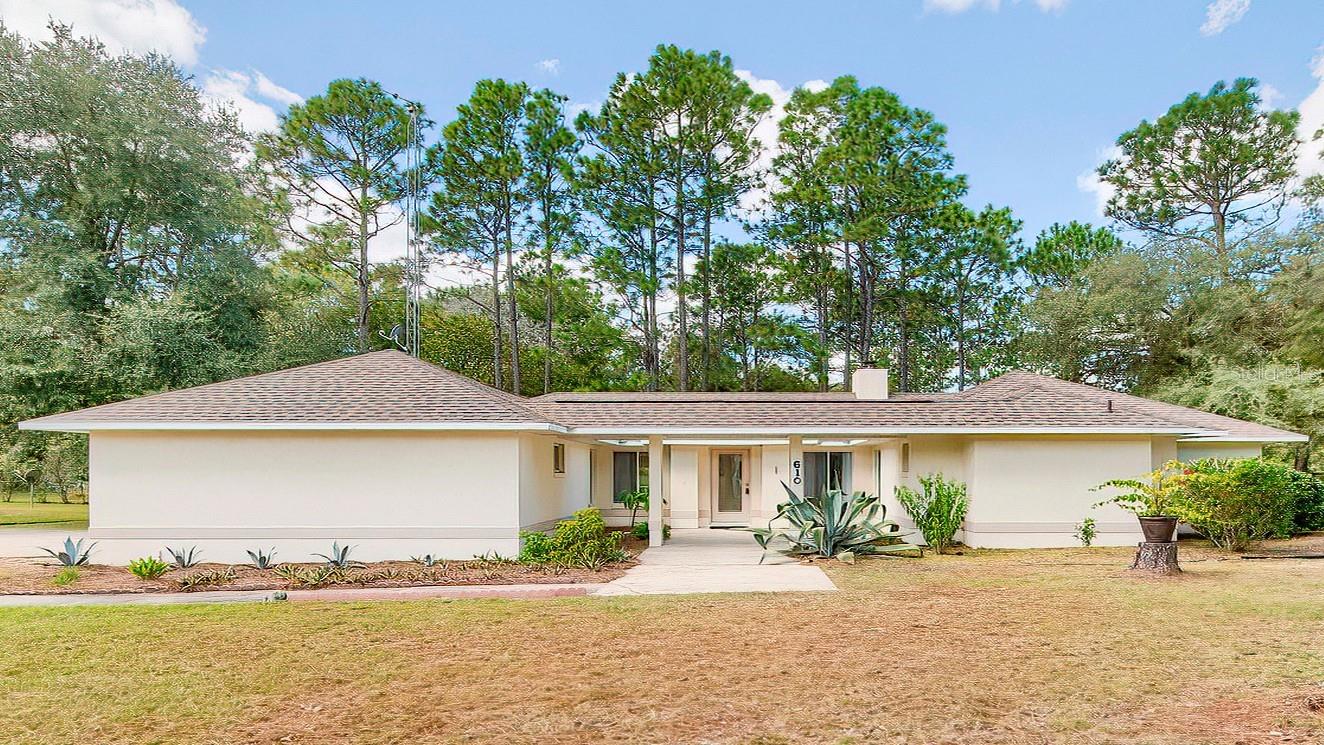 One or more photo(s) has been virtually staged. Auction Property. LIST PRICE IS FOR MLS PURPOSES ONLY. ACTUAL PRICE WILL BE DETERMINED AT AUCTION. ONLINE AUCTION ENDS NOV. 19 AT 1 PM ET. Just outside the city of Williston, Florida, in the Williston Highlands Golf & Country Club, this 2BR/2BA home with 1,471± sf living area and 2,313± sf under roof catches a gentle cross-breeze through large picture windows overlooking tall longleaf pines with graceful canopies. It’s the perfect blend of tranquility and Florida sunshine—a place to enjoy the seasons without the snow. Here, evenings feel like glamping under the stars, yet fine dining and creative local businesses are just minutes away. From country hoedowns under pole barns at Homestead Park to unique shops, cafés, and even Two Tails Elephant Ranch, Williston offers simplicity, individuality, and access to Devil’s Den Spring, Blue Grotto, Cedar Lakes Woods & Gardens, and more. Train, lease, or board horses and host events at Black Prong Equestrian Village. Spacious .74± acre lot with plenty of space. The home was built in 1992± with concrete block construction and stucco exterior. New roof in 2024 and new central A/C in 2025. Eat-in kitchen with natural light, stainless fridge, and electric range with beach themed colors. Neutral tile in kitchen and baths; carpet in bedrooms and living area. Vaulted ceiling with skip-trowel texture. Split bedroom floor plan with open layout and wood-burning fireplace. Large picture and vertical slider windows. Marble window sills throughout. Laundry area in two-car garage with garage door opener and paved turn-pad driveway. Property #: DG1709. Bid Online November 13 - 20. Bidding will start at $190,000. 10% Buyer's Premium. Subject to the final bid at the online auction and auction terms.