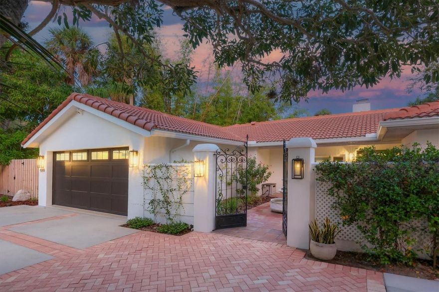 Start living the relaxed island lifestyle in this incredibly impressive Siesta Key waterfront home. This newly renovated modern, warm, move-in ready residence is perfectly positioned at the point of a basin to take advantage of its unique water front location that maximizes privacy and the tranquil water and garden views. Boat, Jet Ski, kayak, paddleboard from the dock, walk to the beach and village, or retreat to the pool and relax in this amazing indoor/outdoor living space. You will love the completely transformed open environment including entry, great room, lounge, kitchen, dining space, wine/coffee bar and laundry creating a stunning, functional, and comfortable feel throughout. The “Florida Friendly” landscaping features native plants, shrubs, and perennials that adorn the property and create a welcoming feel especially as one approaches through the private front courtyard. Once inside, the full wall of sliding doors to the pool and patio gives way to the stunning water view just beyond. Beautiful engineered hardwood floors, vaulted beamed ceilings, and a stone fireplace are just a few of the features that enhance the entryway and large great room. The heart of the home is the amazing kitchen featuring custom cabinetry with paneled appliance doors, natural stone and quartzite countertops, tile backsplash, Blanco sinks, walk-in pantry, and an extra-large rectangular island with storage and seating. High-end appliances include a Sub-Zero French Door refrigerator, GE Monogram Induction cooktop, French Door wall oven, Advantium microwave oven, Kitchen Aid dishwasher, and a Scotsman ice maker. The primary suite is a retreat and boasts Saltillo tile floors, sliding door access to the lanai, a walk-in closet, a long vanity with dual sinks, a jetted tub, and an enclosed shower. There are three additional bedrooms, one with a separate entrance from the front courtyard. Two of the bedrooms have ensuite bathrooms and there is an additional bathroom. An office/flex room and a beautiful yet functional laundry room complete the interior spaces. The outdoor kitchen, covered and uncovered seating areas, pool, paver deck and pathways, and beautiful native landscaping provide an incredible waterfront setting. The garage renovation includes an expansion and raised ceiling, epoxy resin floor covering, a separate 220v outlet for a 50A car charging station, 64 SF of ceiling storage racks, hurricane-resistant doors, built-in workspace, storage, and much more. Additional improvements include exterior and interior painting, window treatments, ceiling fans, plumbing, replaced and expanded gutters, two 4-zone irrigation systems, and garden storage shed. All this just a few minutes’ walk from the powdery white sands of Siesta Key Beach, Siesta Key Village, and all that island living has to offer.