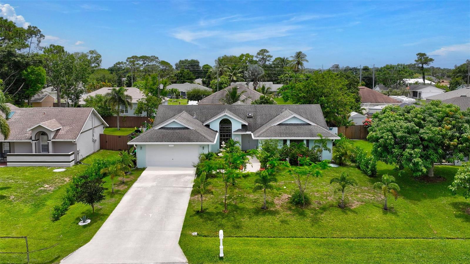 Welcome to your piece of Paradise located at just 20 minutes from the beach, and less than 10 minutes from the Turnpike. This meticulously maintained property boast a versatile layout that accommodate many decoration styles. Featuring 3 bedrooms, 2 bathrooms, 2-car garage, inside laundry room, formal dining room, kitchen/family room combo, tile/laminated flooring, and an oversized screened lanai overlooking a beautifully designed paved patio. The stunning landscape includes fruit trees and exotic plants, providing endless entertainment for nature lovers. The kitchen counts with stainless still appliances, modern backsplash, breakfast bar, and wide windows ideal for family interaction while enjoying the lanai during special celebration. AC replacement to be credited at closing. The master suite counts with two linen closet plus a walking closet to keep everything in place. The master bathroom has dual vanity with makeup desk, garden tub & shower combination for a delightful spa-like experience. Schedule your showing today and get ready to meet your new forever home.
