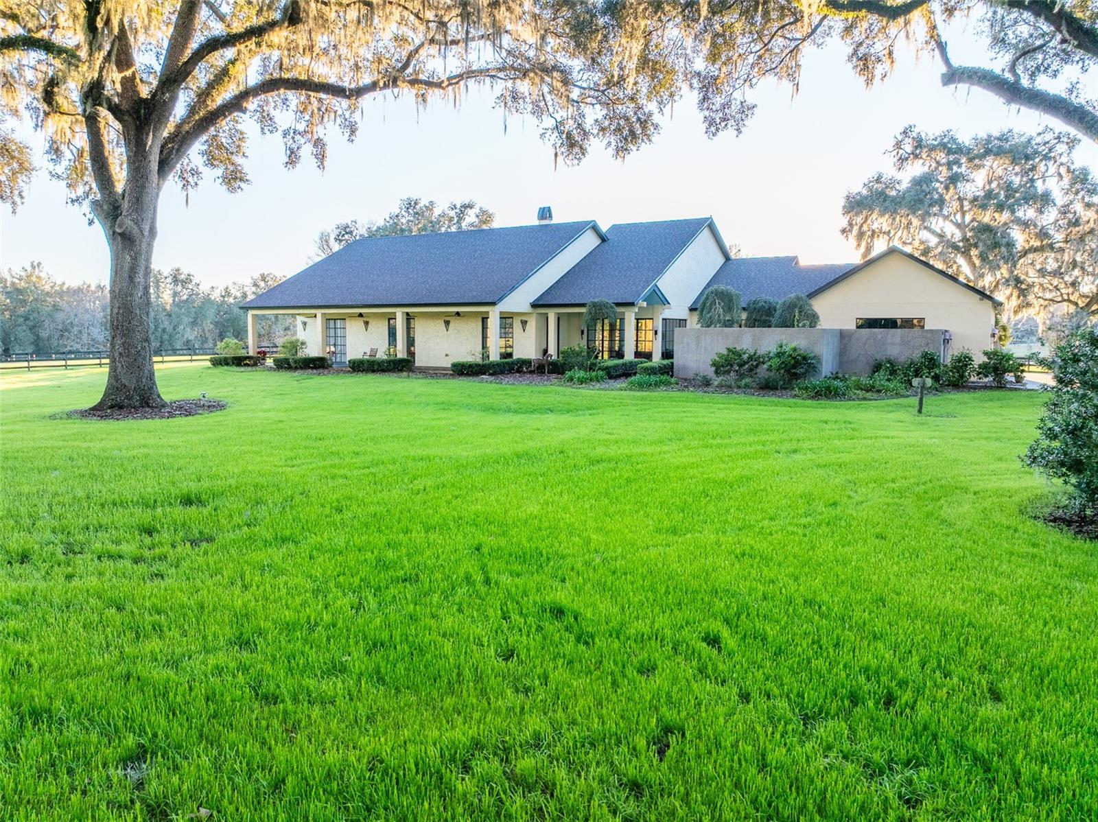 A Timeless Haven Beneath the Oaks: Step back in time to the serene beauty of "Old Florida", where majestic live oaks stretch skyward and silvery moss dances on the breeze. Nestled within this natural wonder lies Moonshadow Farm a singular Executive residence and horse farm thoughtfully designed with timeless grace and enduring luxury.
This exceptional property features a six-stall concrete block shed row barn complete with run-in and plumbed waterer, tack/feed room, and newly renovated apartment that includes a stack washer/dryer. There is a double sized oval ring and ample space for horse trailers behind the barn.
Inside the residence every space is a sanctuary. Three spacious bedrooms, each with ensuite baths enables privacy and comfort. Sun-drenched rooms with soaring ceilings are grounded by rich Brazilian wood flooring.
The heart of residence-a chef's kitchen- boasts a Wolf six-burner double oven range, framed by unique single slab granite backsplash, Sub-Zero fridge and plenty of storage in the almost 9" island. The kitchen flows seamlessly into a Butler's pantry equipped with commercial freezer, Wolf electric wall oven, warming drawer, cooktop and second dishwasher-ideal for elegant entertaining and grand gatherings.
Two luxurious Primary suites, one on each side of the residence invite privacy and comfort. Throughout the sanctuary, steel French doors open each room to light and landscape, creating a stunning connection to the surrounding beauty.
With elegant craftsmanship in every detail, Moonshadow Fram is not just a property- it's a masterpiece waiting to be experienced.
