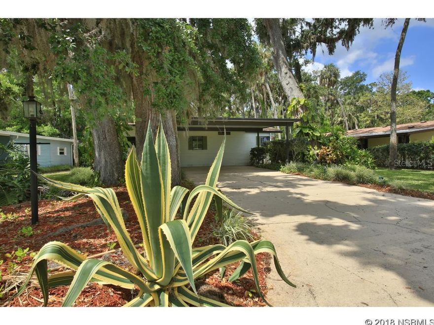 One of a kind floor plan with an open concept.  Entryway opens to kitchen and large living area which has a sliding glass door to the glassed-in, tiled Florida room that captures the entire backyard and natural area-so private and secluded. There are 2 wood decks for BBQ and relaxing.  New kitchen cabinets, countertops in 2004, New refrigerator and dishwasher in 2015. New Roof in 2015 -     Home is tiled and wood laminate in bedrooms.  Dining area has build-in storage space,  Slider off the master bedroom leads to the tiled Florida room.  Guest bedroom has a full size Murphy bed system with extra built-in storage.  Double carport -  Partially furnished. Short walk to path leading to the clubhouse, pool, hot tub, fitness center and fishing pier.  Loads of activities.  Resident private boat launch on the Intracoastal Waterway.  Come join the carefree lifestyle and drive around in your own golf cart in a gated Community. This Home is Move-In Ready and features Low HOA fees -- ;Water: City