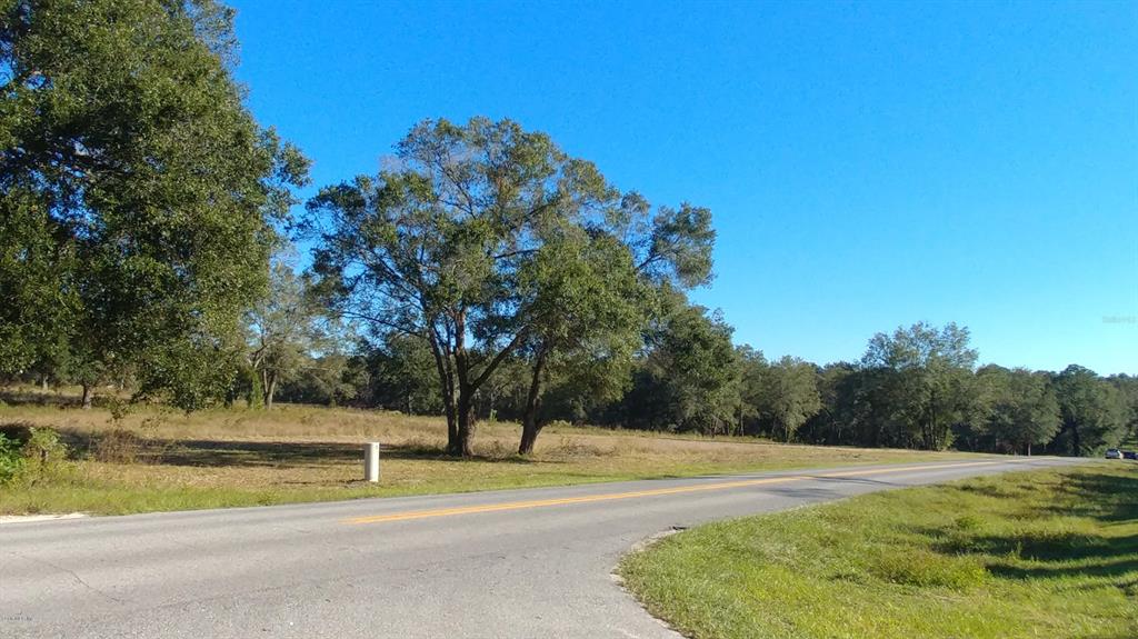 Under contract-accepting backup offers. On just under 19 and a half acres in Lady Lake, this parcel of land has plenty of potential for a variety of uses with a zoning of R-4 for Residential Mixed Use. Located less than 10 minutes to The Villages®, this parcel offers road frontage on three sides and a fantastic location for a shopping center, apartments or townhomes, or even an assisted living facility if desired. An approved plat is available for a mixed-use complex, and city utilities are already on property. Most of the property is cleared with some remaining trees that offer nice options for landscaping and gentle shade. If you're looking for the perfect property to develop, look no further!